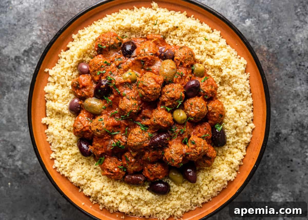 overhead: moroccan lamb meatball in a bowl with sauce