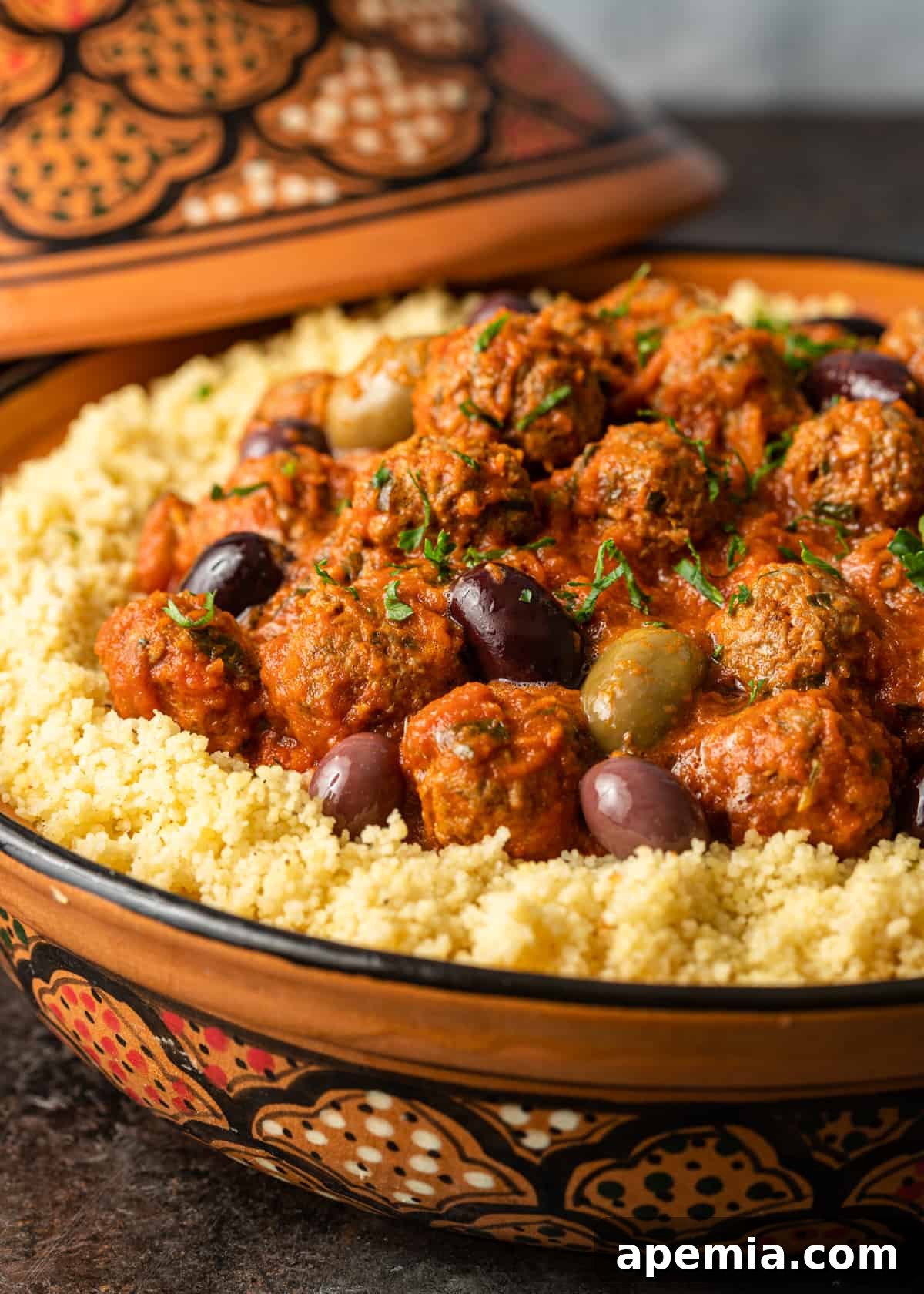 closeup side view: ready to serve Moroccan Meatballs in a bowl, garnished