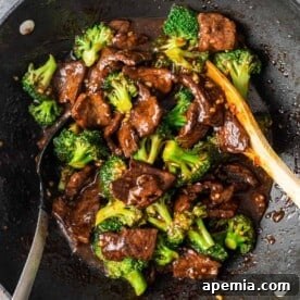 Broccoli beef in a wok with a spoon