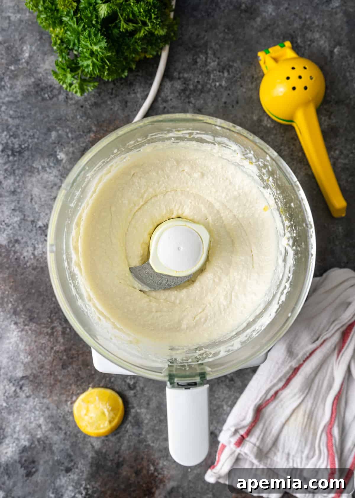 overhead process shot: whipped feta dip in food processor
