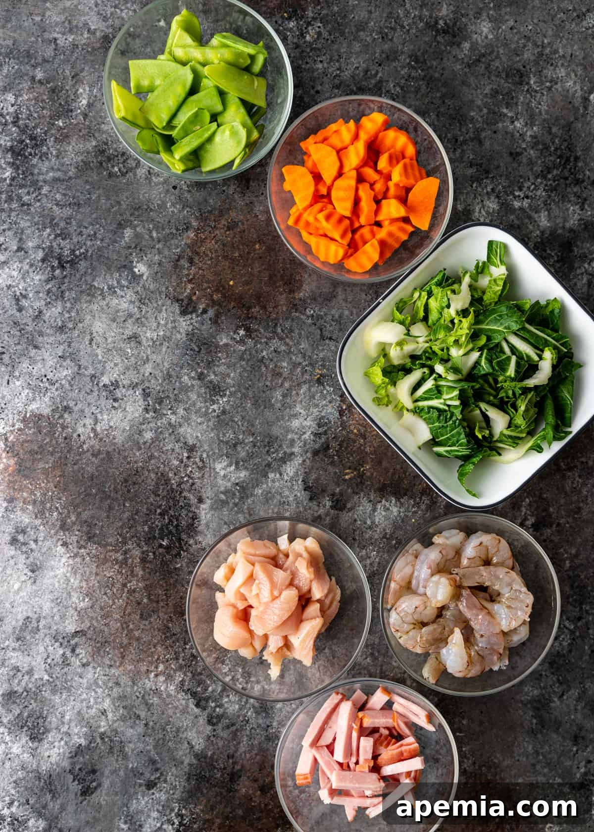 An array of fresh, uncooked ingredients laid out, ready for making Sizzling Rice Soup