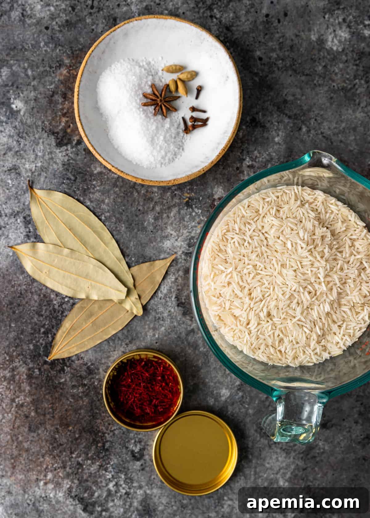 overhead: dry rice and ingredients in bowls for chicken biryani
