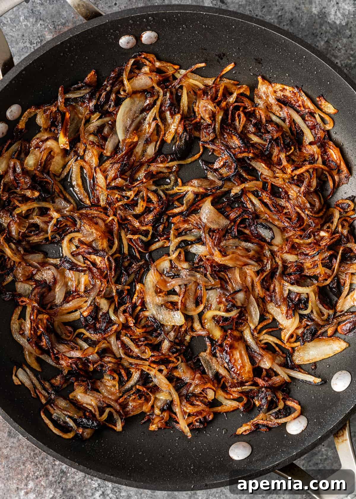 overhead process shot: cooked onions in a skillet