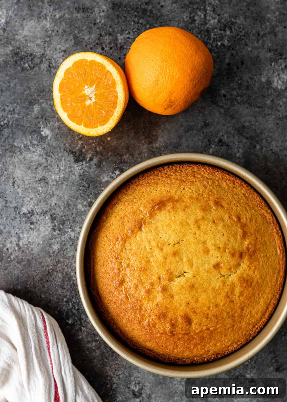 Process shot: the baked olive oil cake cooling on a wire rack after being removed from the oven.