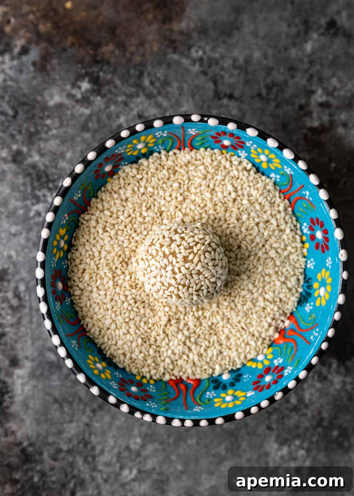 overhead process shot: coating cookie dough in sesame seeds