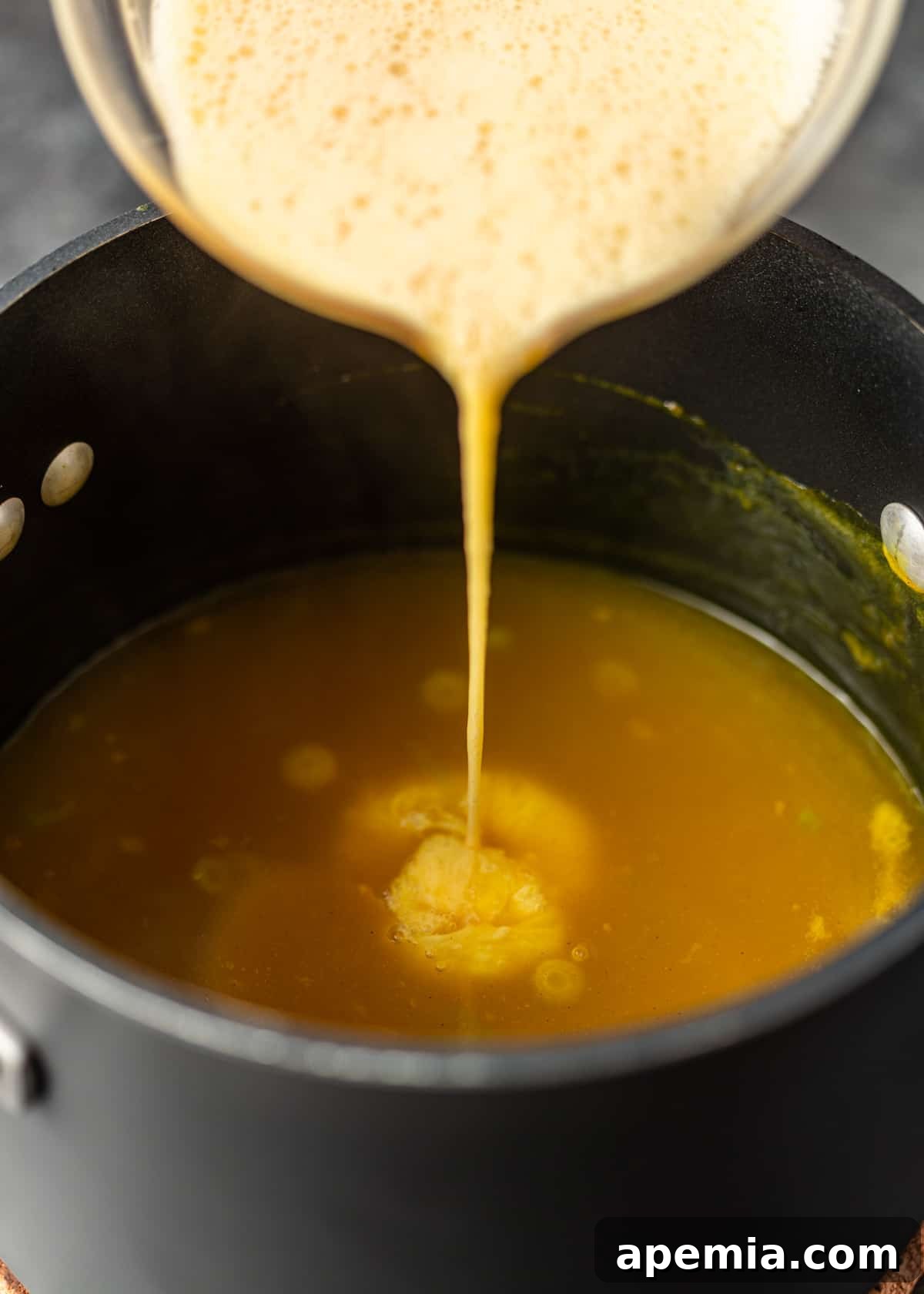 pouring ingredients into pan