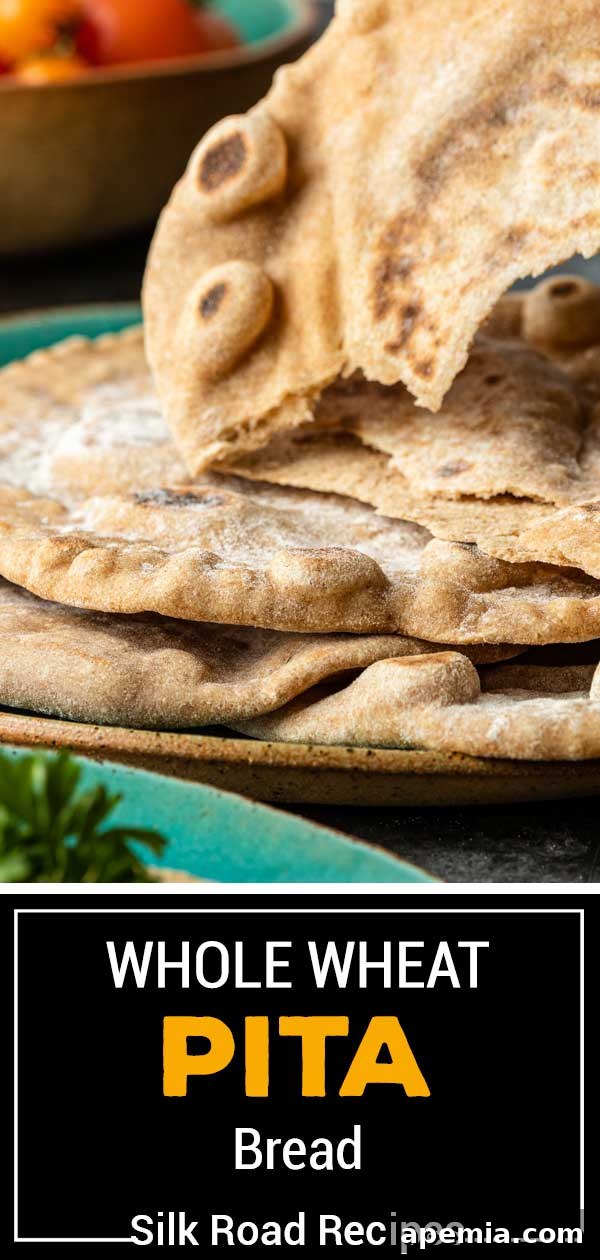 A towering stack of warm, fresh whole wheat pita bread, showcasing its fluffy and inviting texture, ready to be enjoyed.