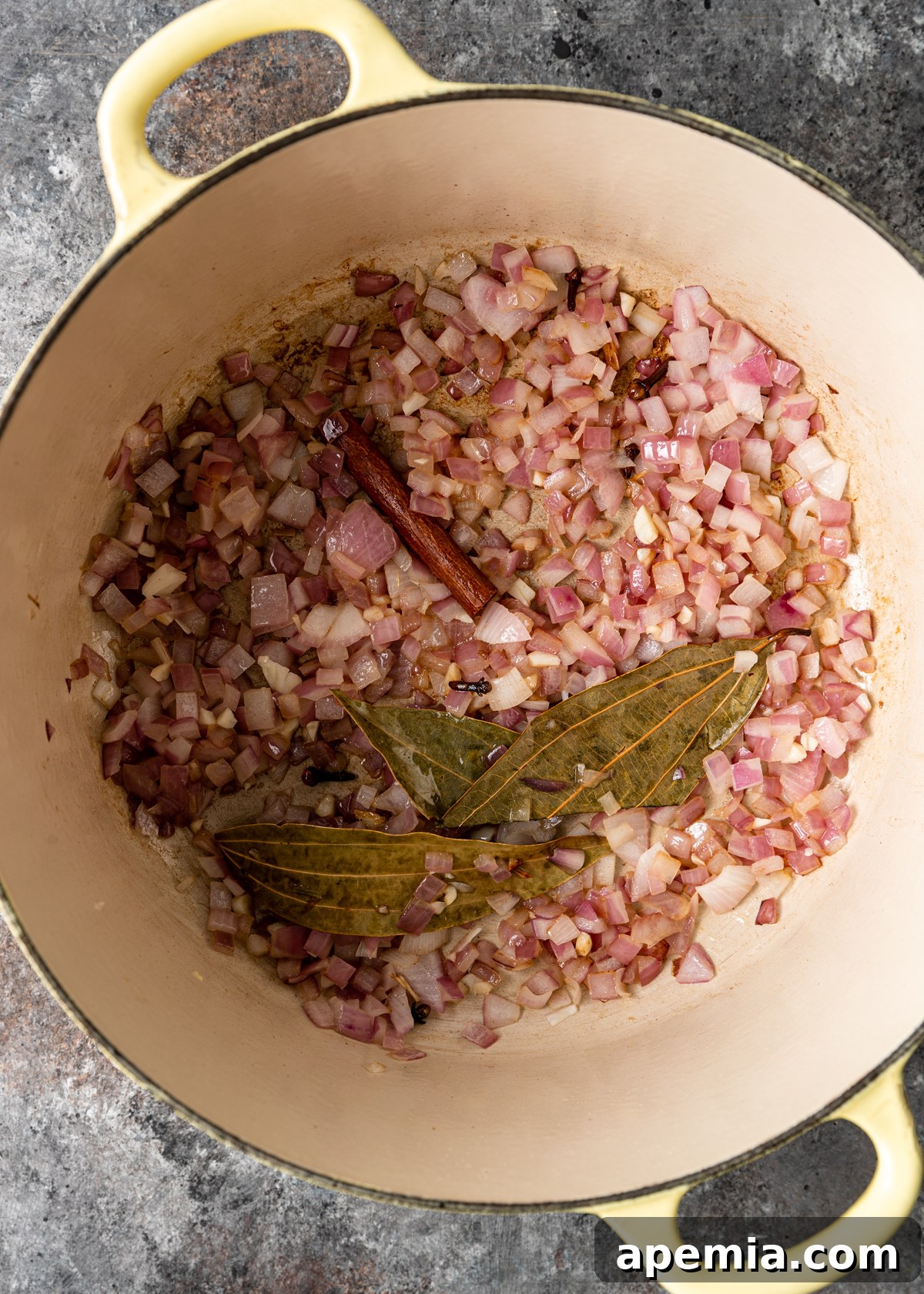 overhead process shot: titled image (and shown) fry onions and spices
