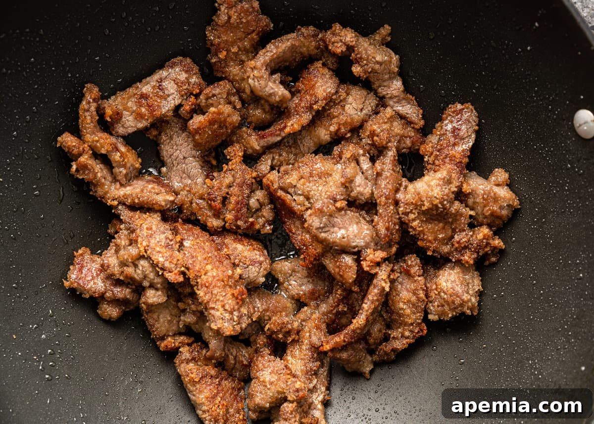 overhead: beef cooking in a wok