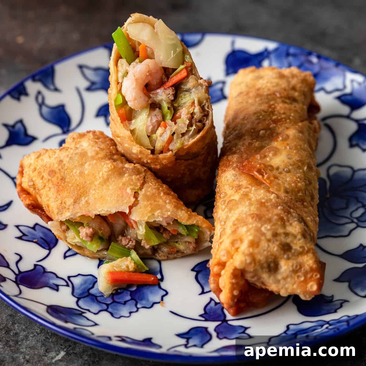 Perfectly Crispy Egg Rolls 2 closeup side view: egg rolls on blue and white plate