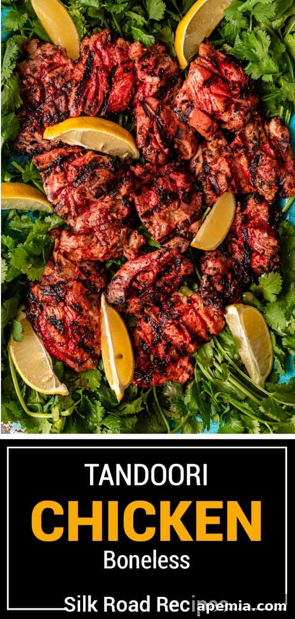 Final serving platter with multiple pieces of Tandoori Chicken, garnished with herbs and lemon slices