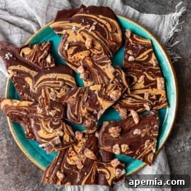 A square image of the finished Tahini Chocolate Bark, highlighting its marbled layers and toppings.