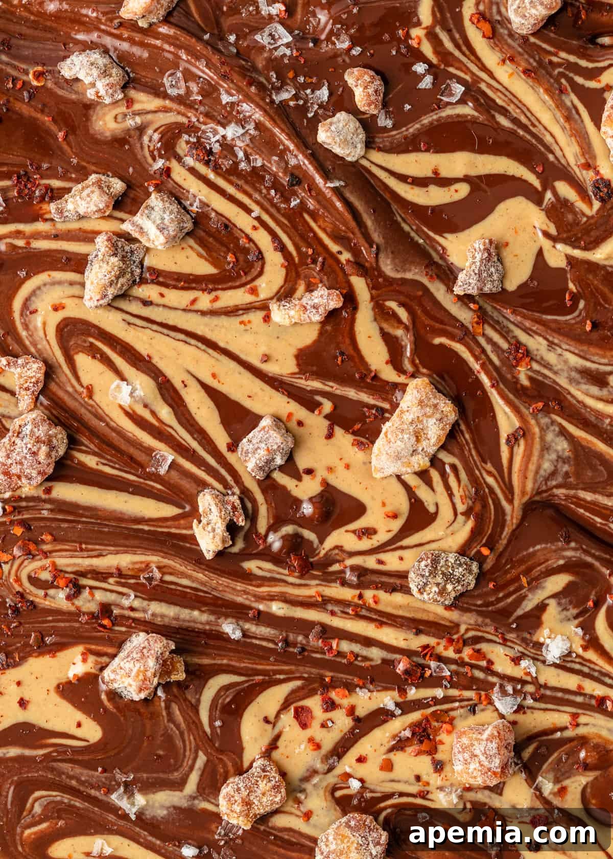 Closeup of Tahini Chocolate Bark showing the finished marbling and toppings, ready to be frozen until firm.