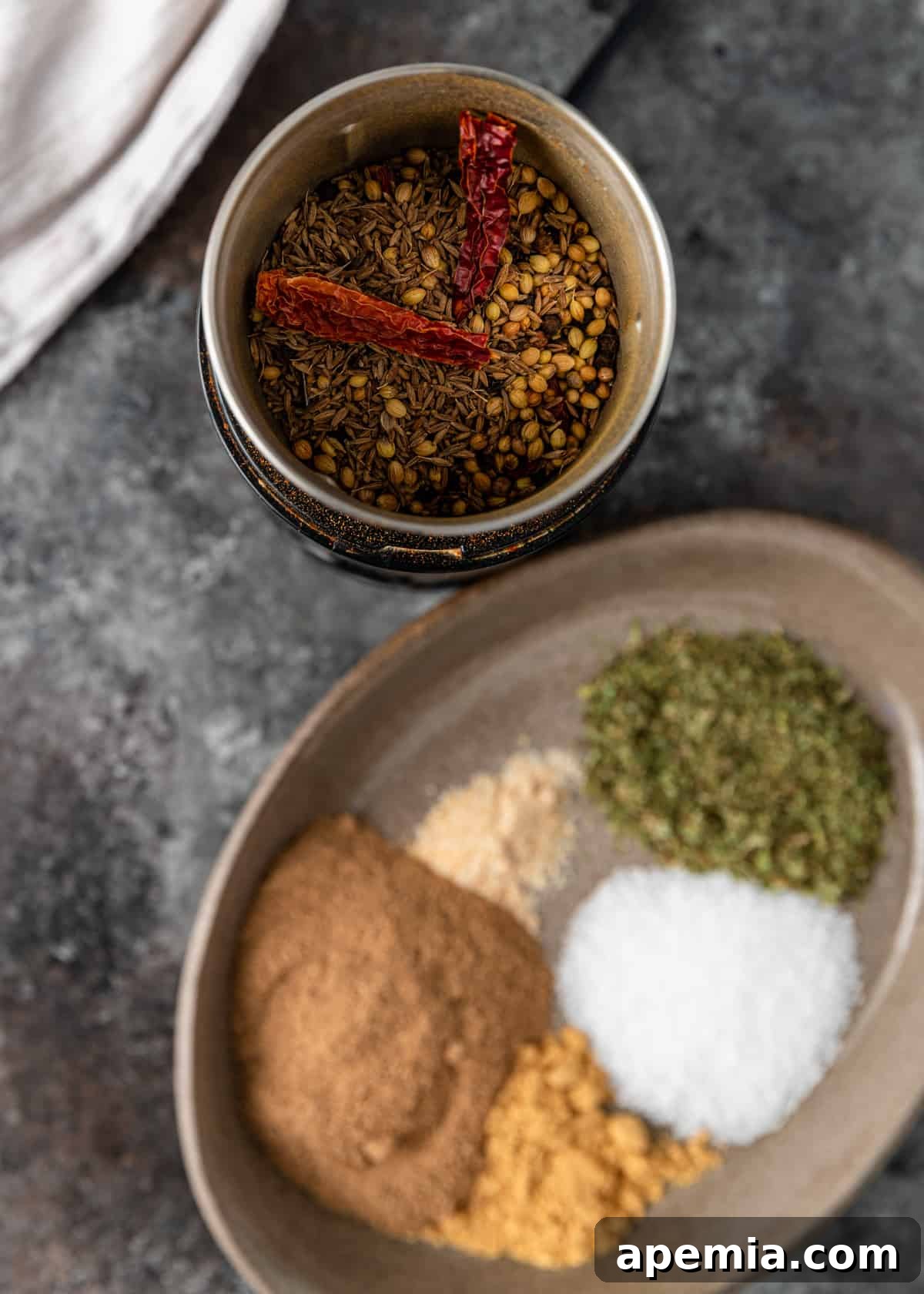 An overhead view capturing the precise steps of preparing chaat masala, with spices being measured and blended in a clean kitchen environment.