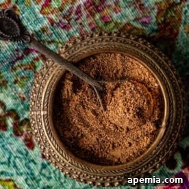 A square image showcasing the final homemade chaat masala powder, glistening and ready to be used as a seasoning.