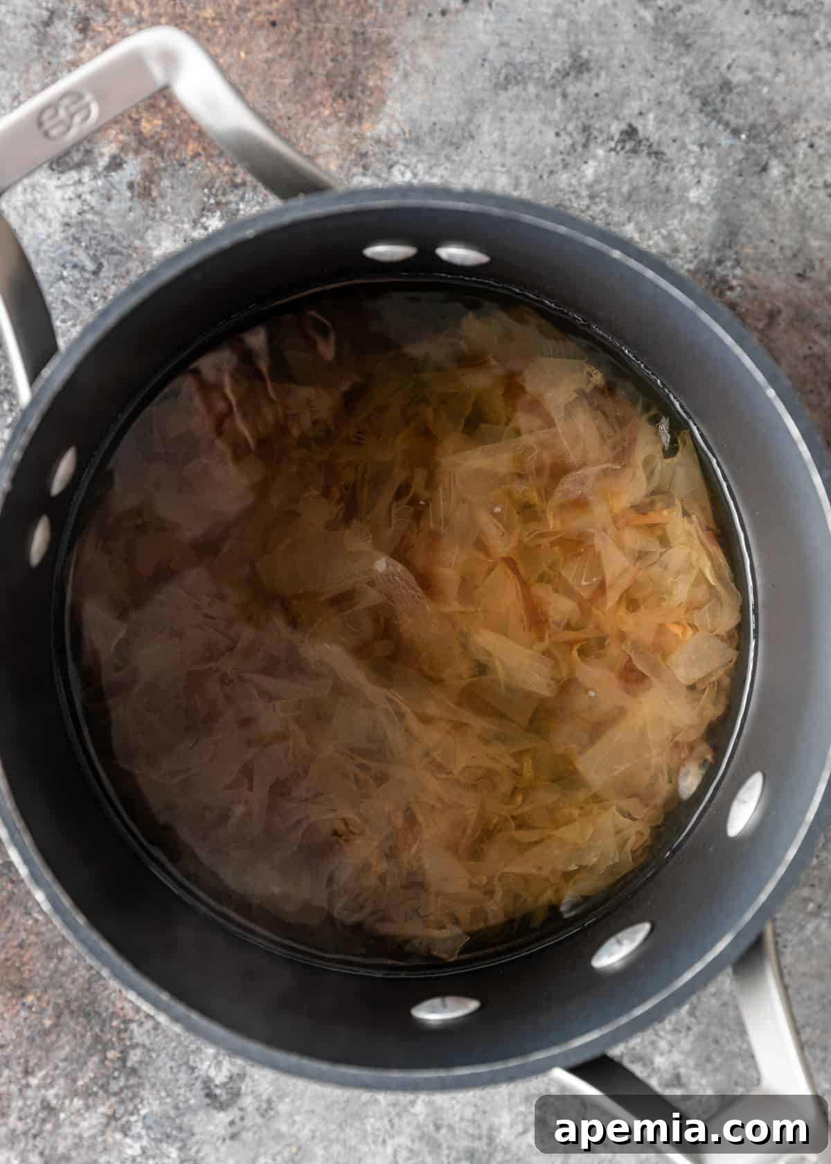 Dried bonito flakes steeping in hot water to create dashi stock.