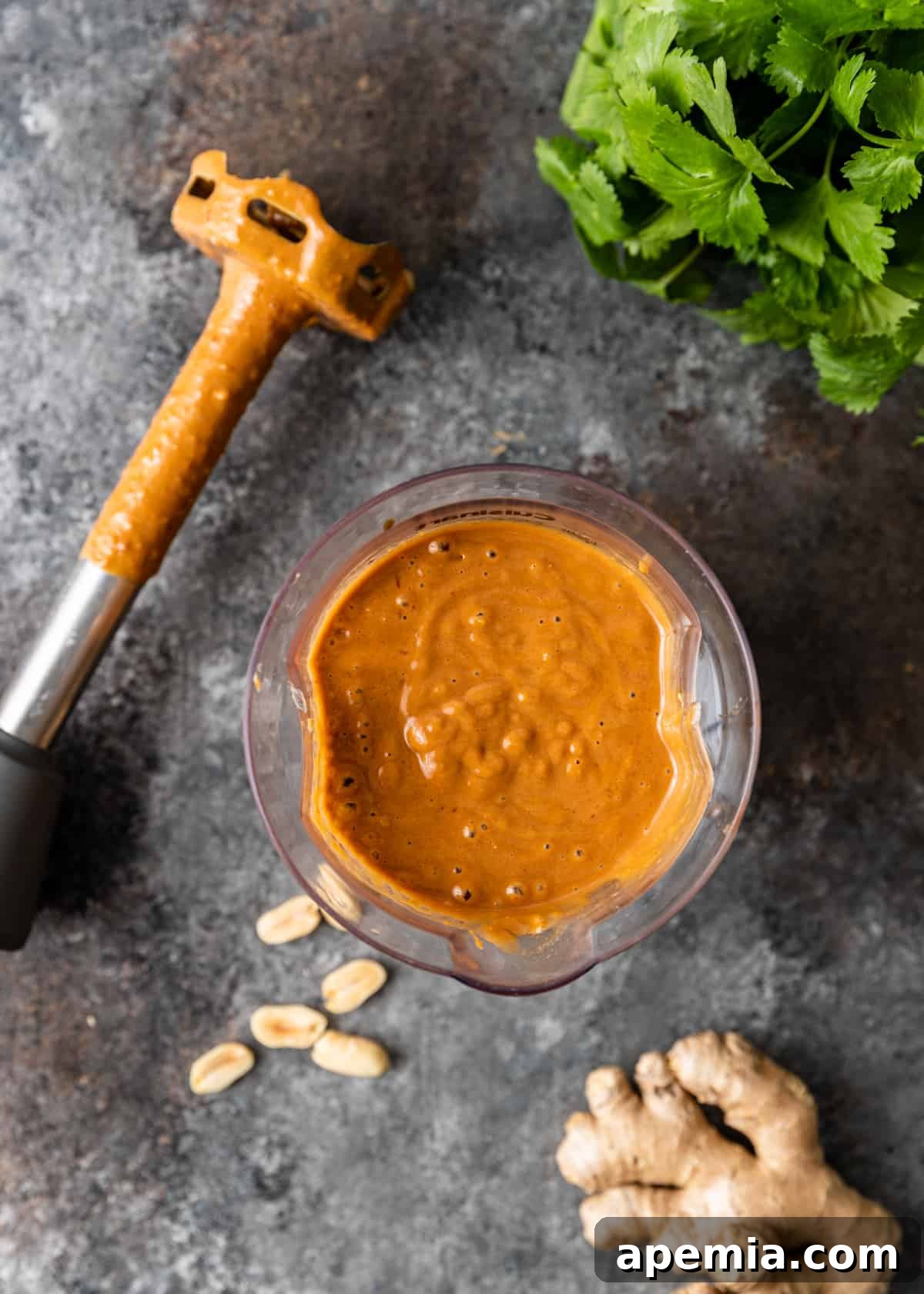 Close-up of peanut sauce blending smoothly in a blender, illustrating the easy preparation process.