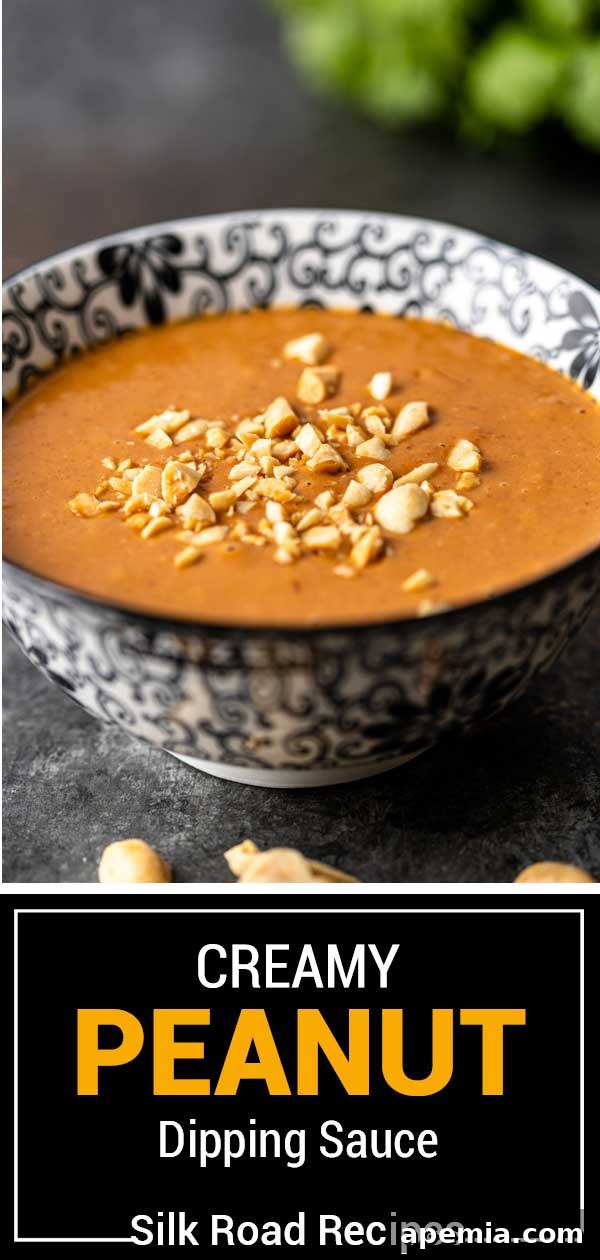 Side view of a black and white bowl filled with creamy peanut sauce, ready for serving.