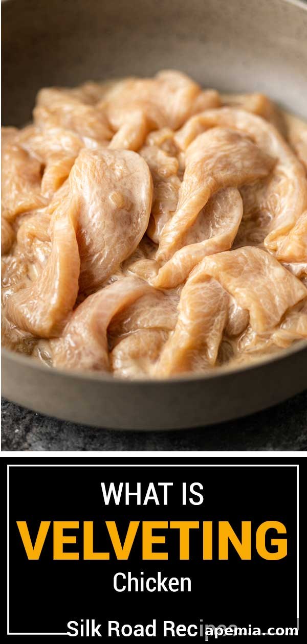 A bowl of perfectly velveted chicken, ready for any stir-fry or Asian dish.