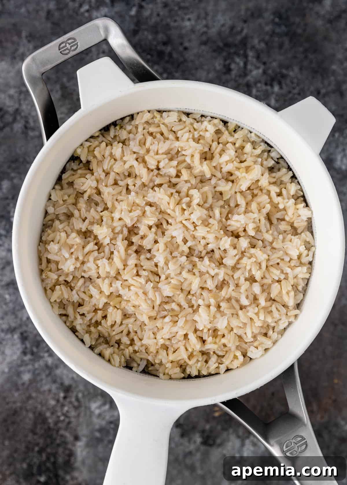 overhead shot of cooked rice in sieve