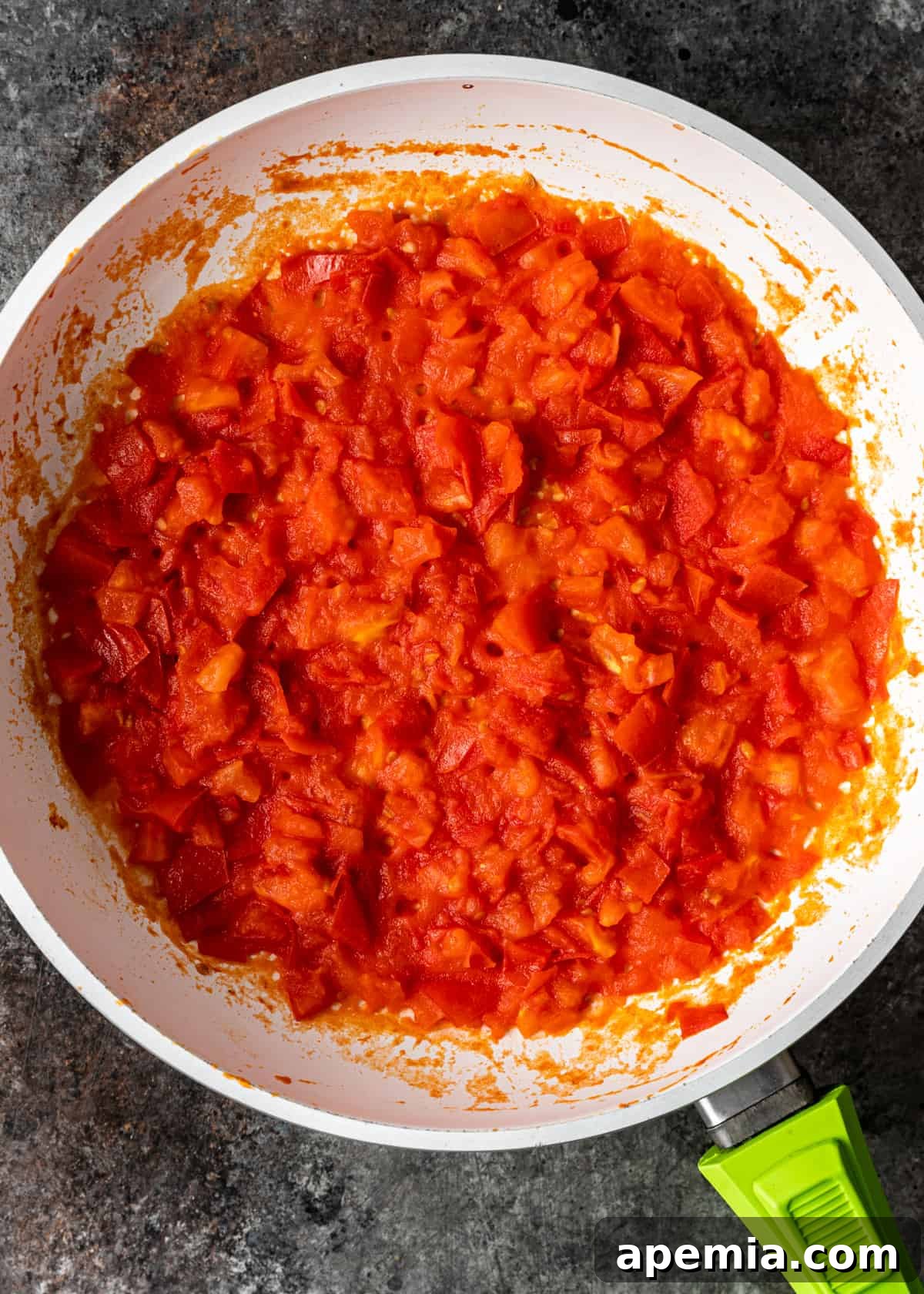 Sweet Heat Tomato Chutney 6 Overhead process shot: Cooked tomatoes in a skillet, significantly reduced and softened, ready for the next step.