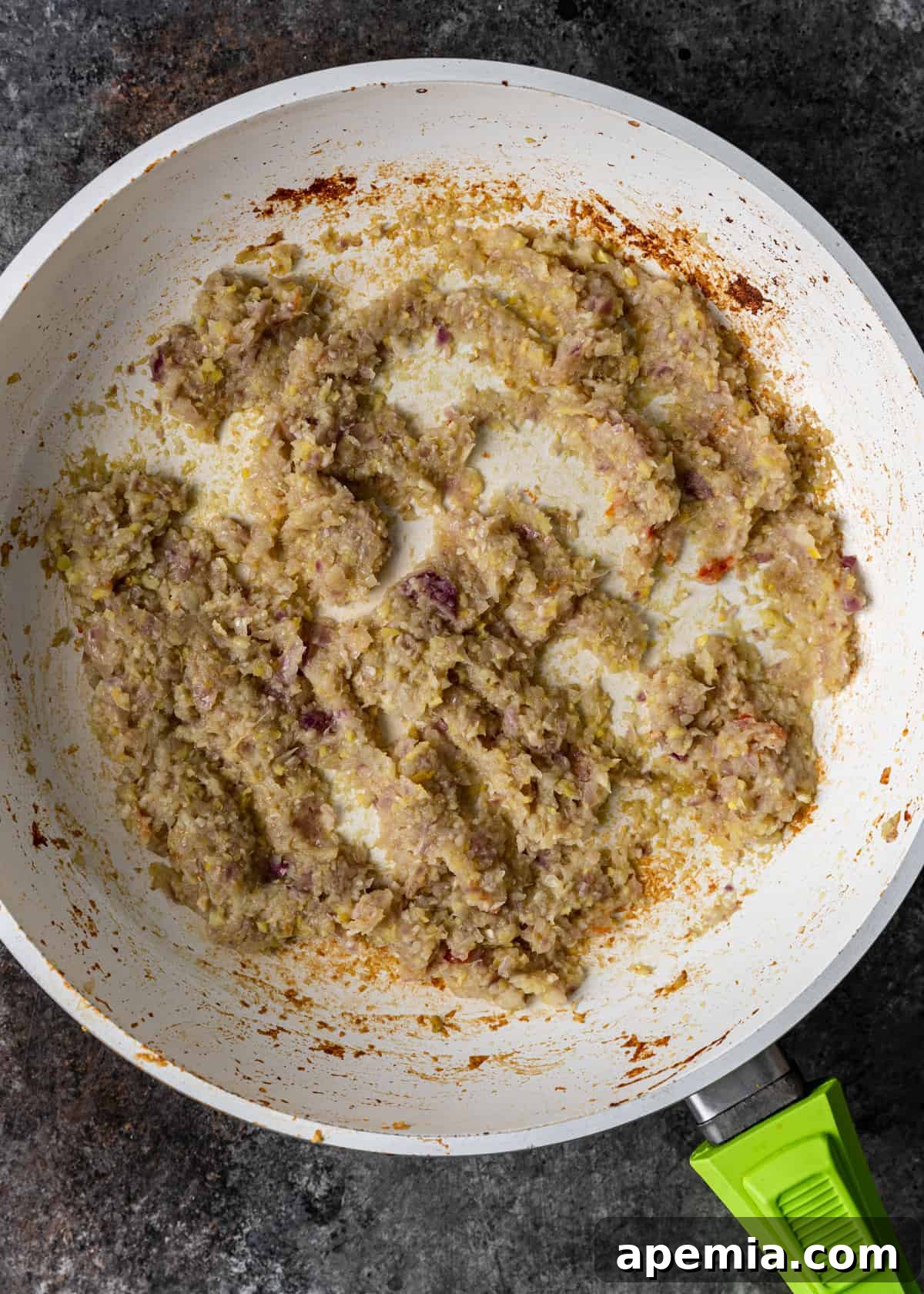 Sweet Heat Tomato Chutney 8 Overhead process shot: Skillet with reduced aromatics and spices, combined and thickening into a chutney.