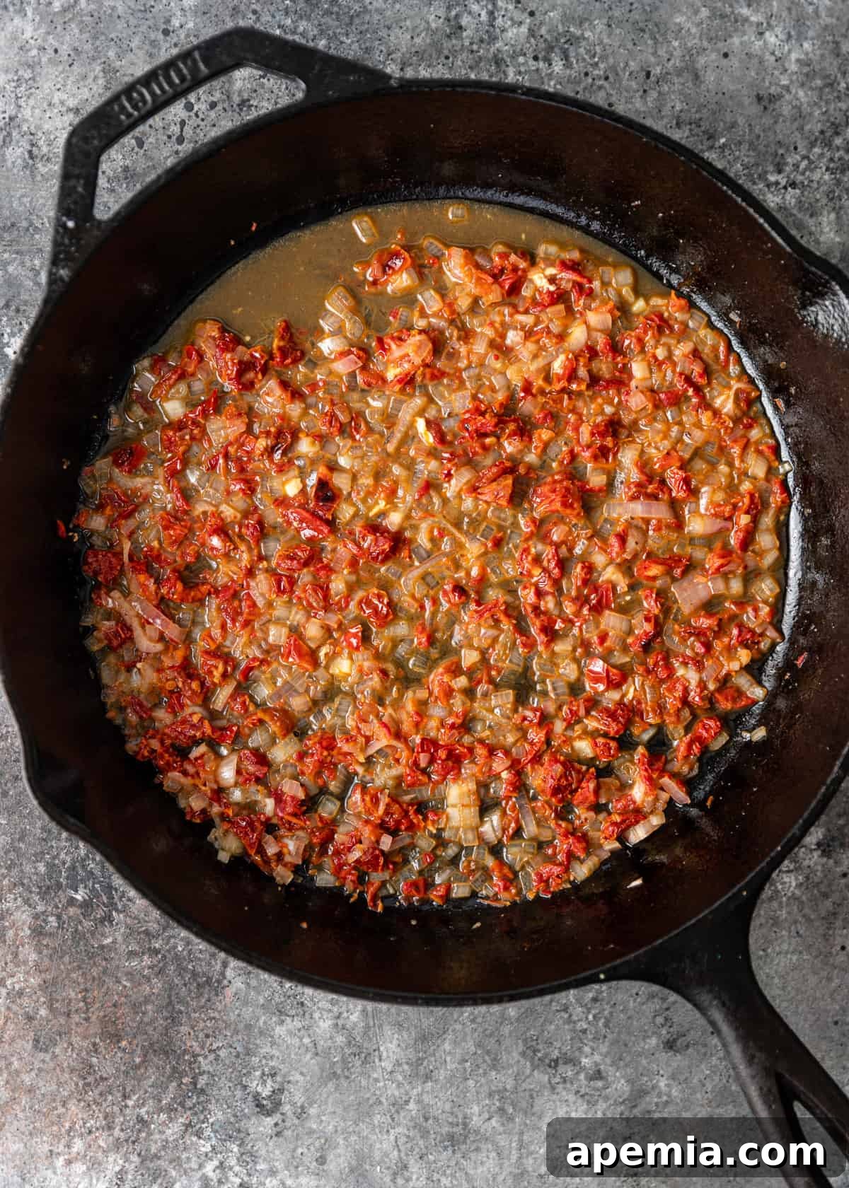 Tomatoes, shallots and wine simmering in a skillet
