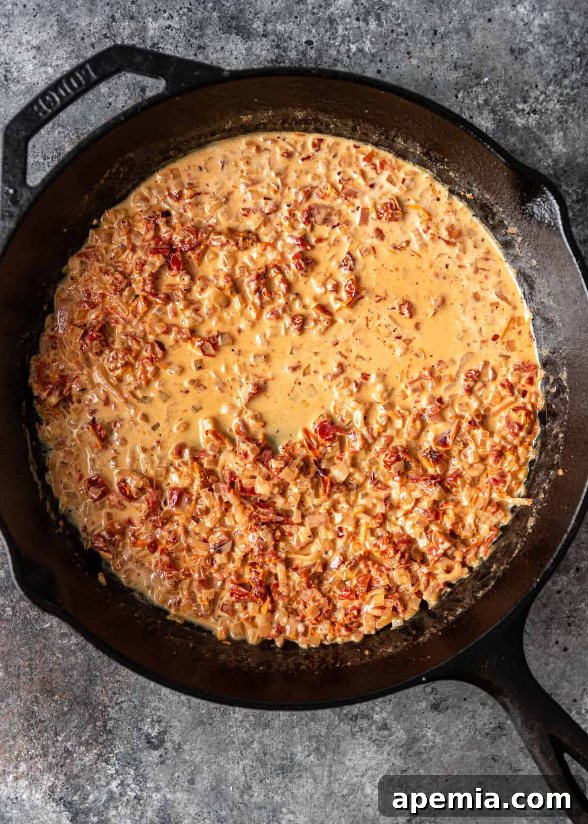 Adding cream to reduce and thicken the sauce