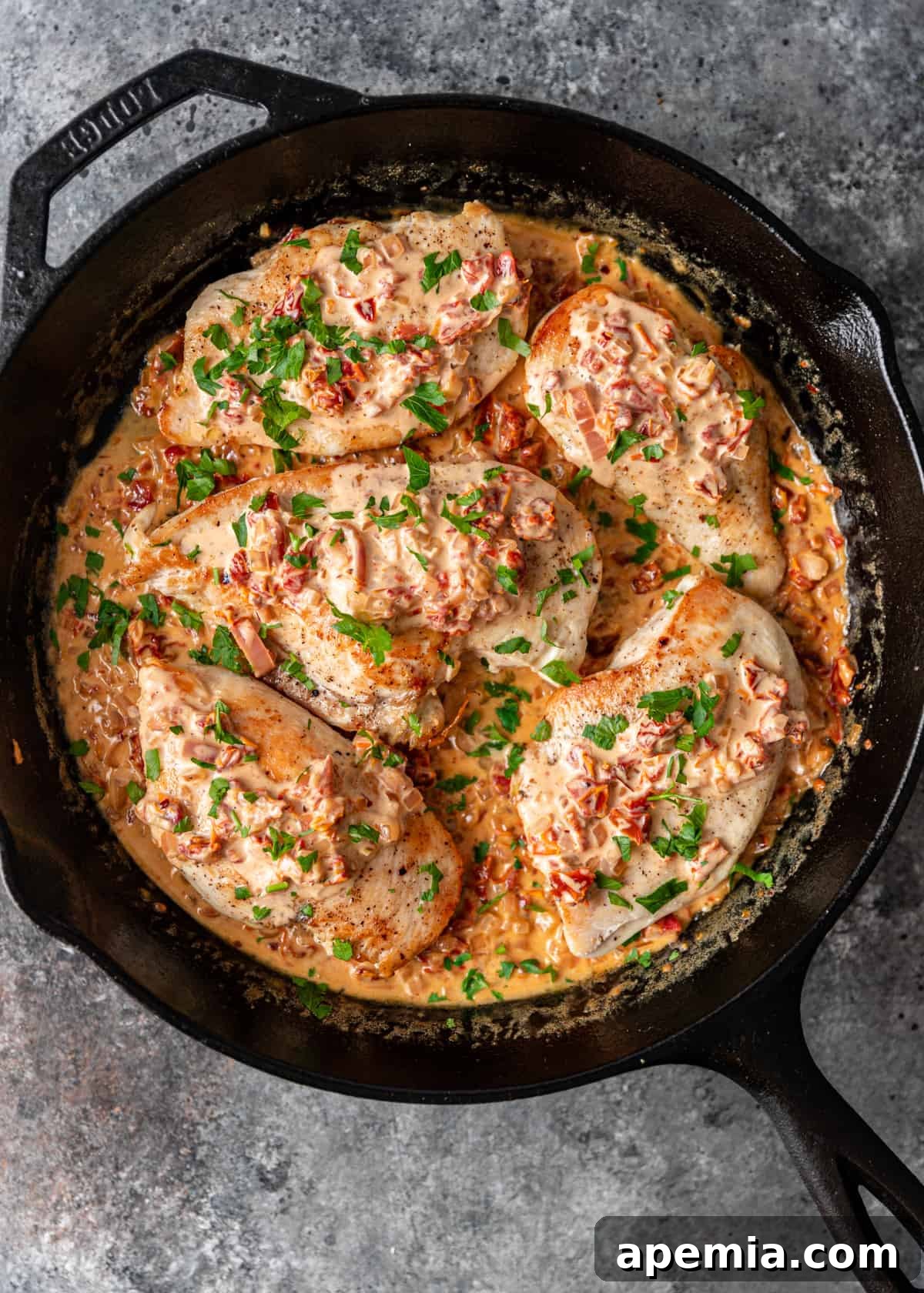 Coating chicken in creamy Tuscan sauce