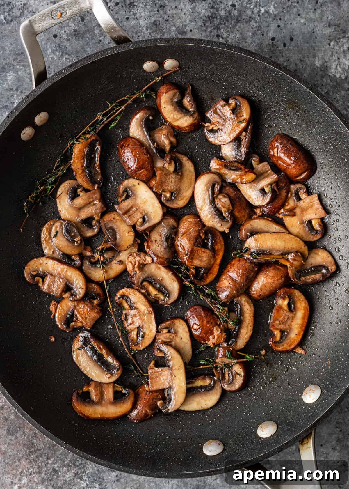 Rich and Creamy Marsala Chicken 6 mushrooms cooking in a skillet