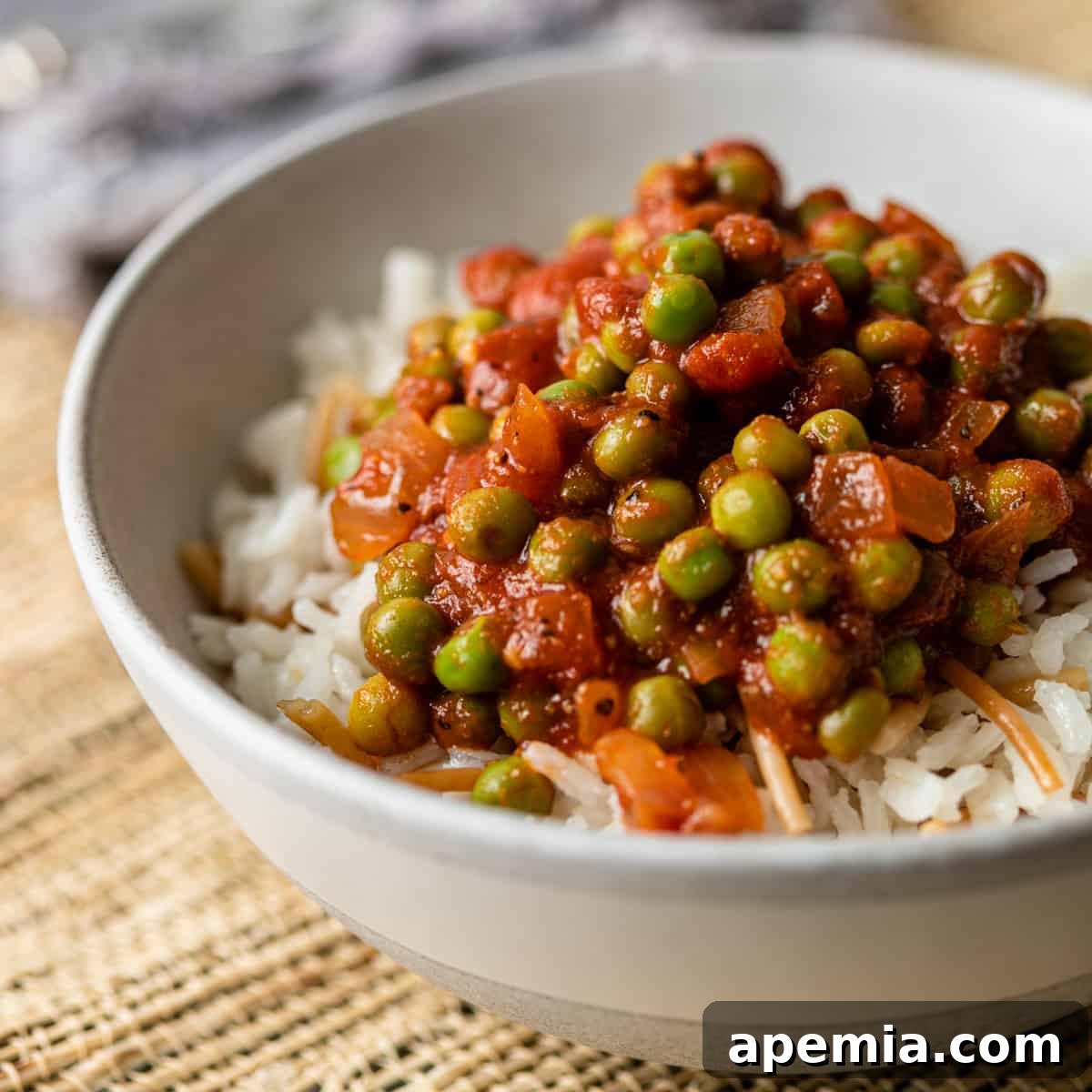 close up of Egyptian pea stew in a bowl with rice and vermicelli