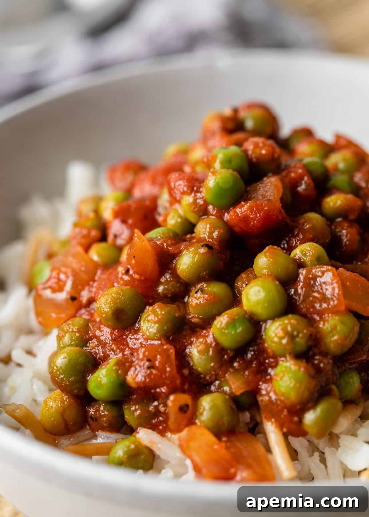 close up of Egyptian pea stew in a bowl with rice