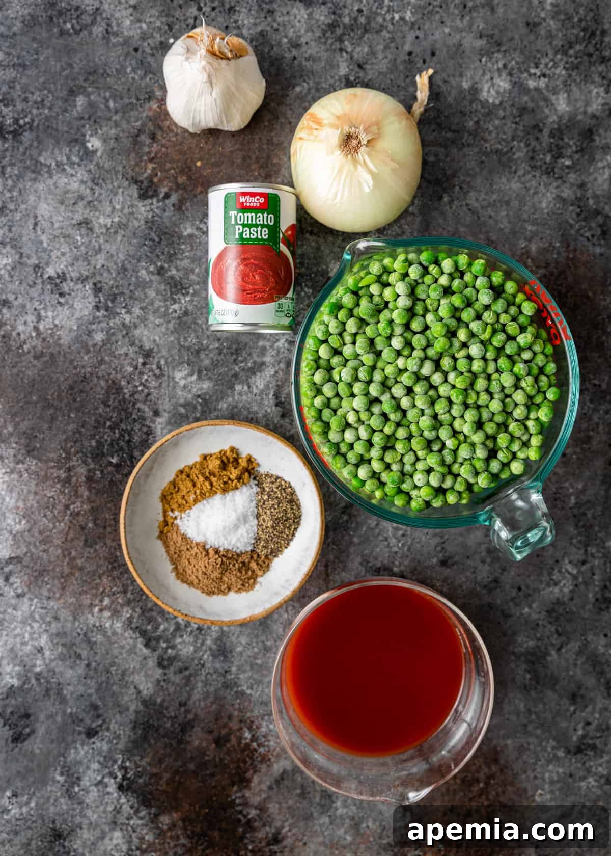 top down view of Egyptian pea stew ingredients: onion, garlic, peas, spices, tomato paste