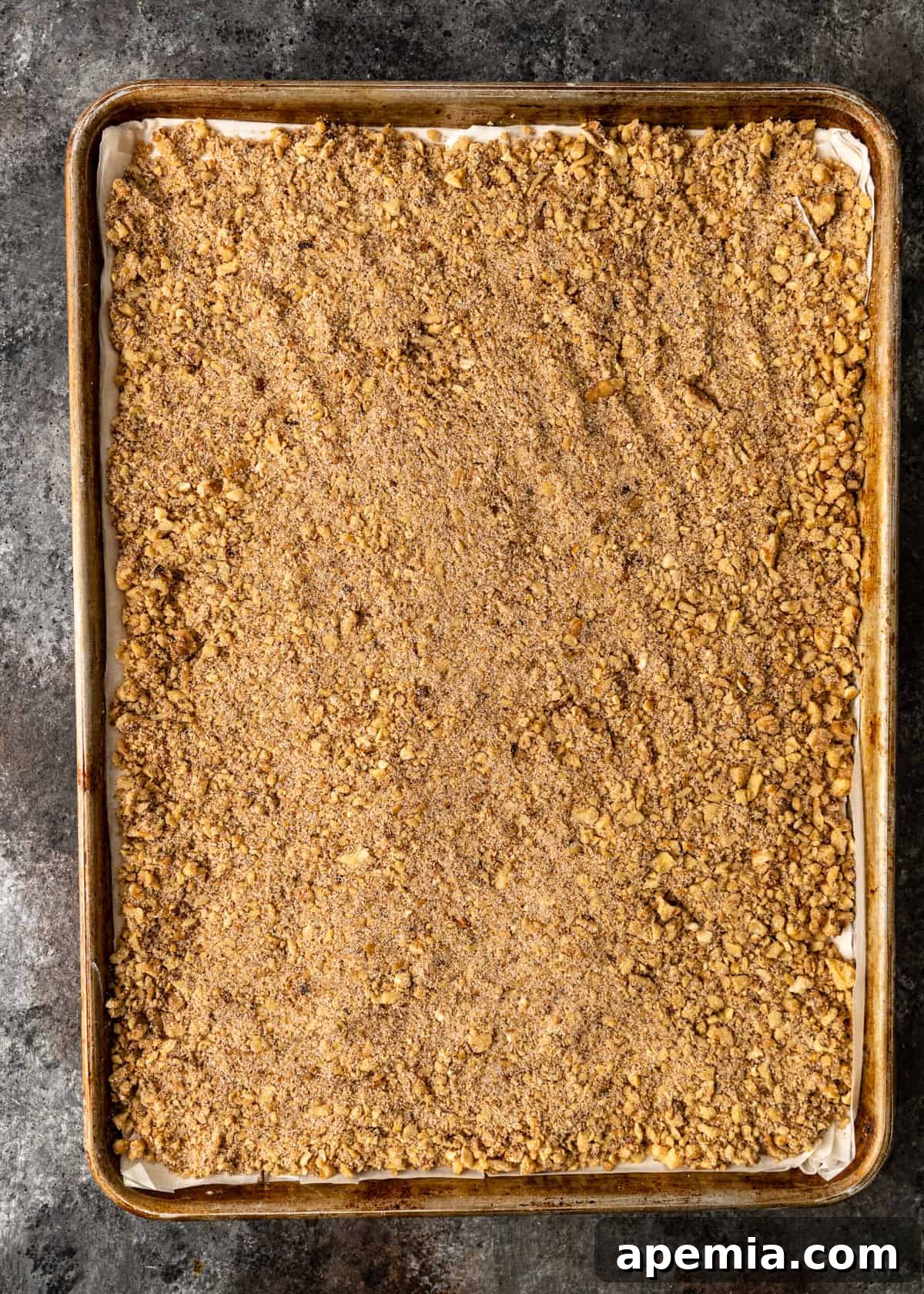 Sweet Greek Baklava Made Simple 8 spread nuts and spices on top of phyllo dough in a greased pan