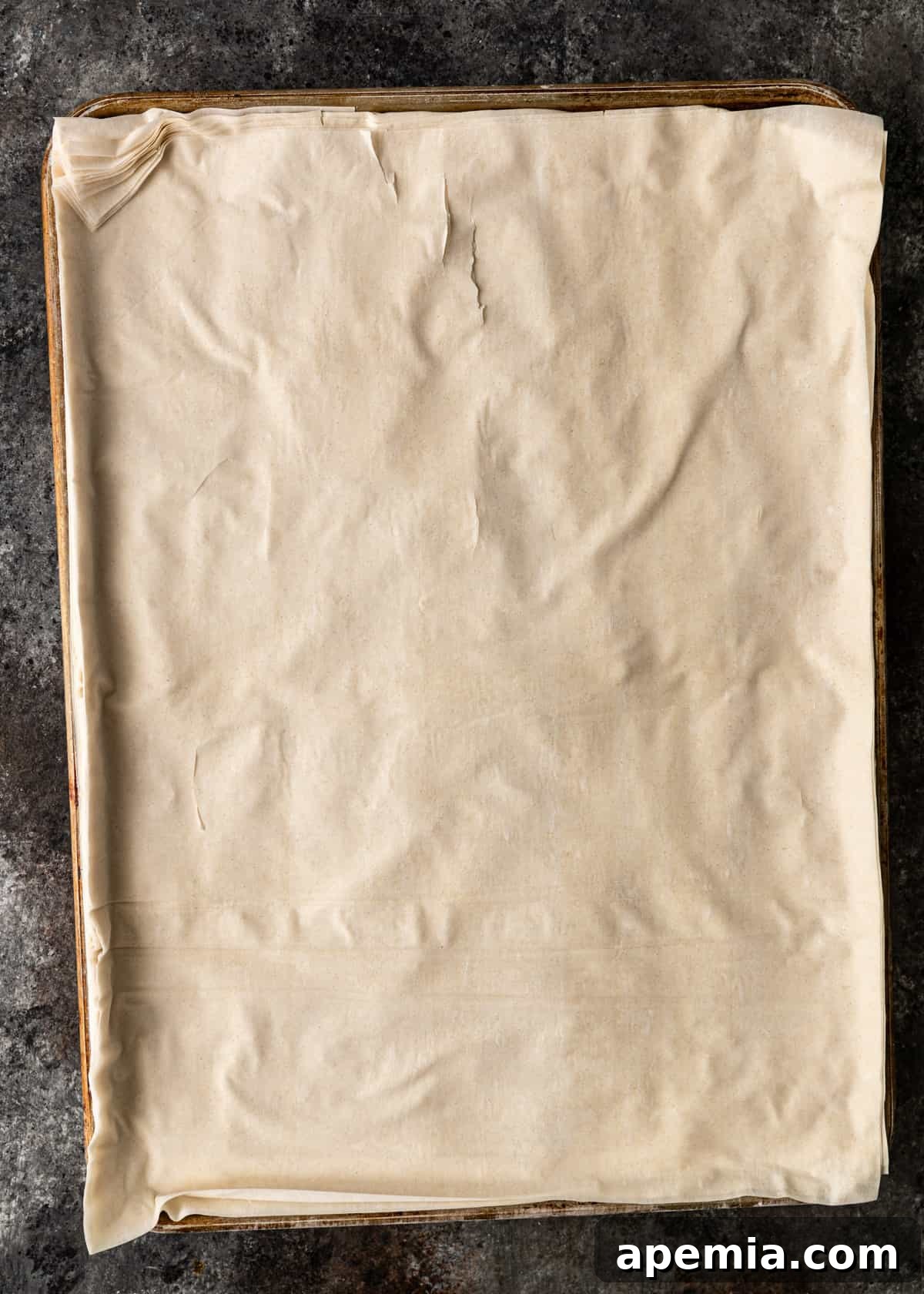 Sweet Greek Baklava Made Simple 9 top down view of phyllo dough on a baking sheet