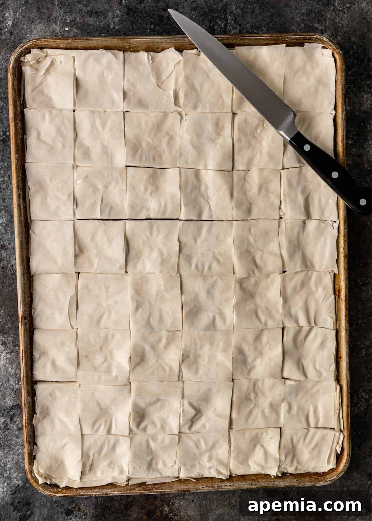 Sweet Greek Baklava Made Simple 10 top down view of uncooked cut baklava on a baking sheet