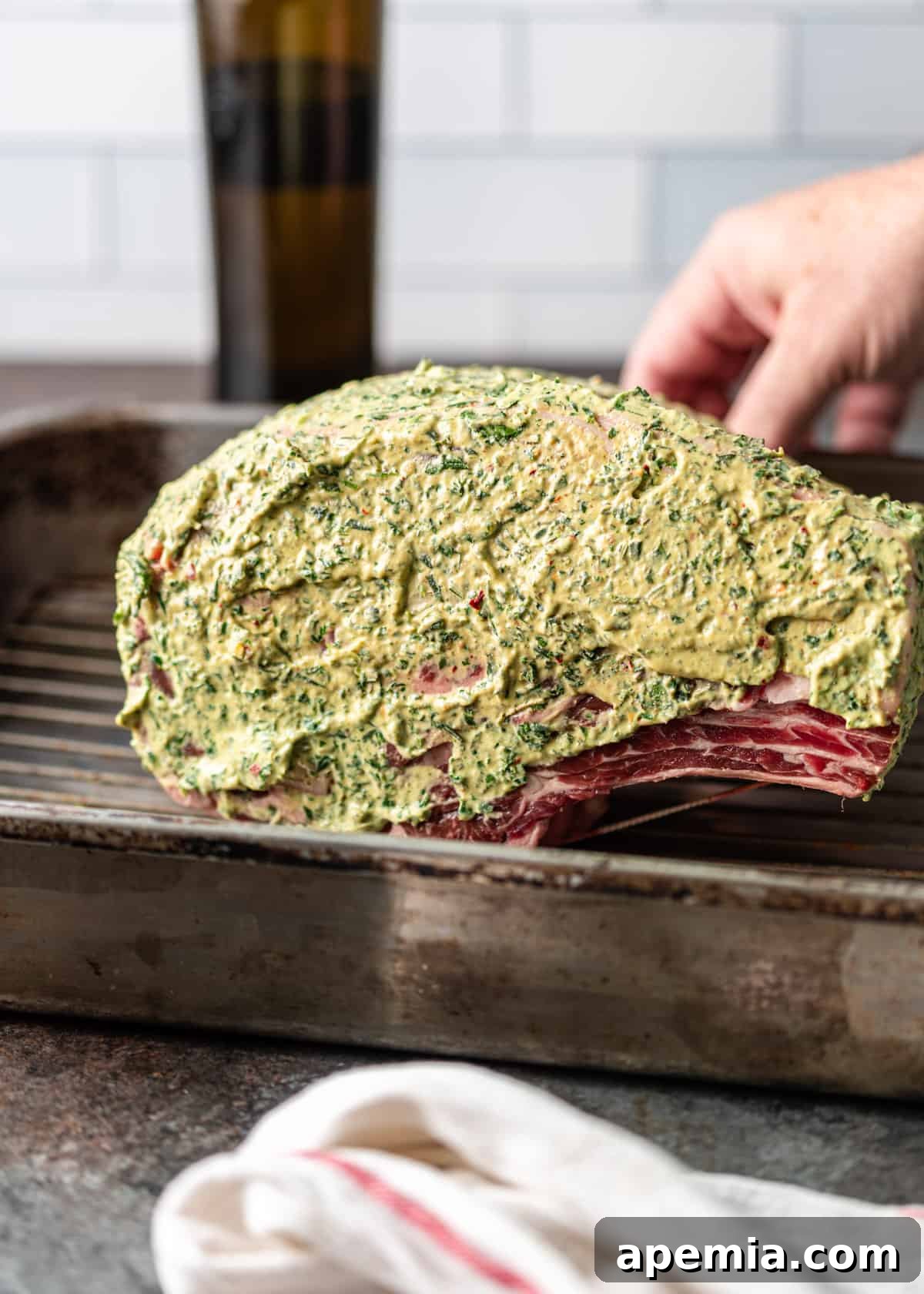 side view: prime rib smothered in mustard and herb rub
