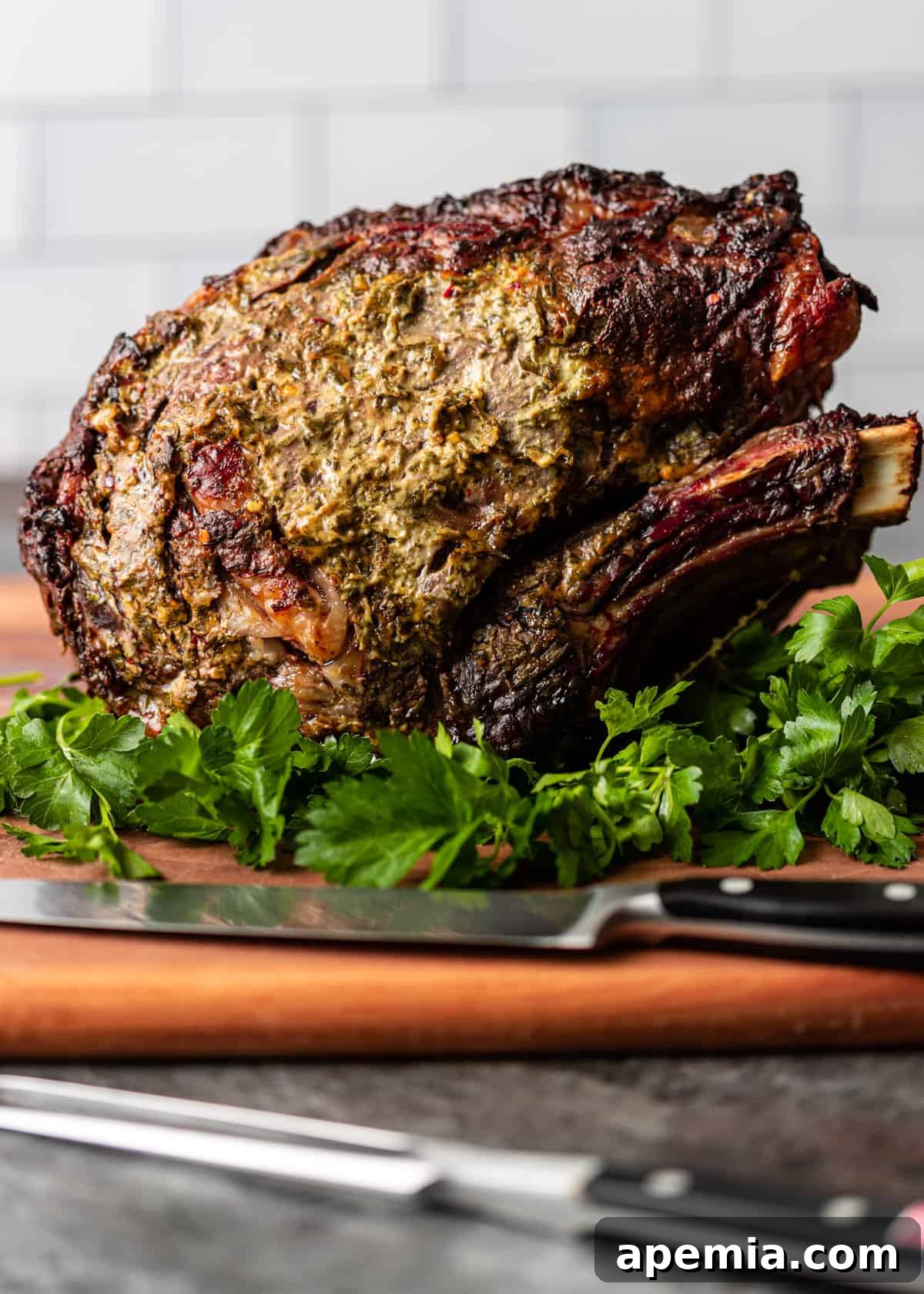 side view: cooked prime rib recipe over fresh herbs