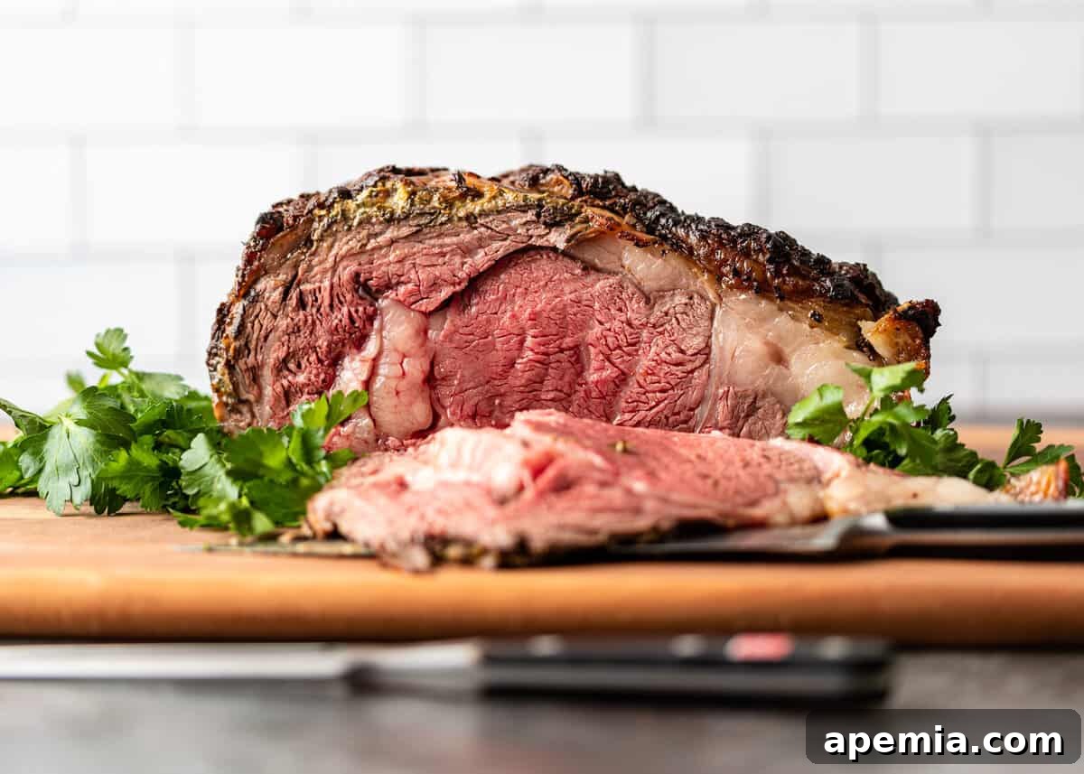 side view: prime rib roast over fresh herbs with a slice taken out
