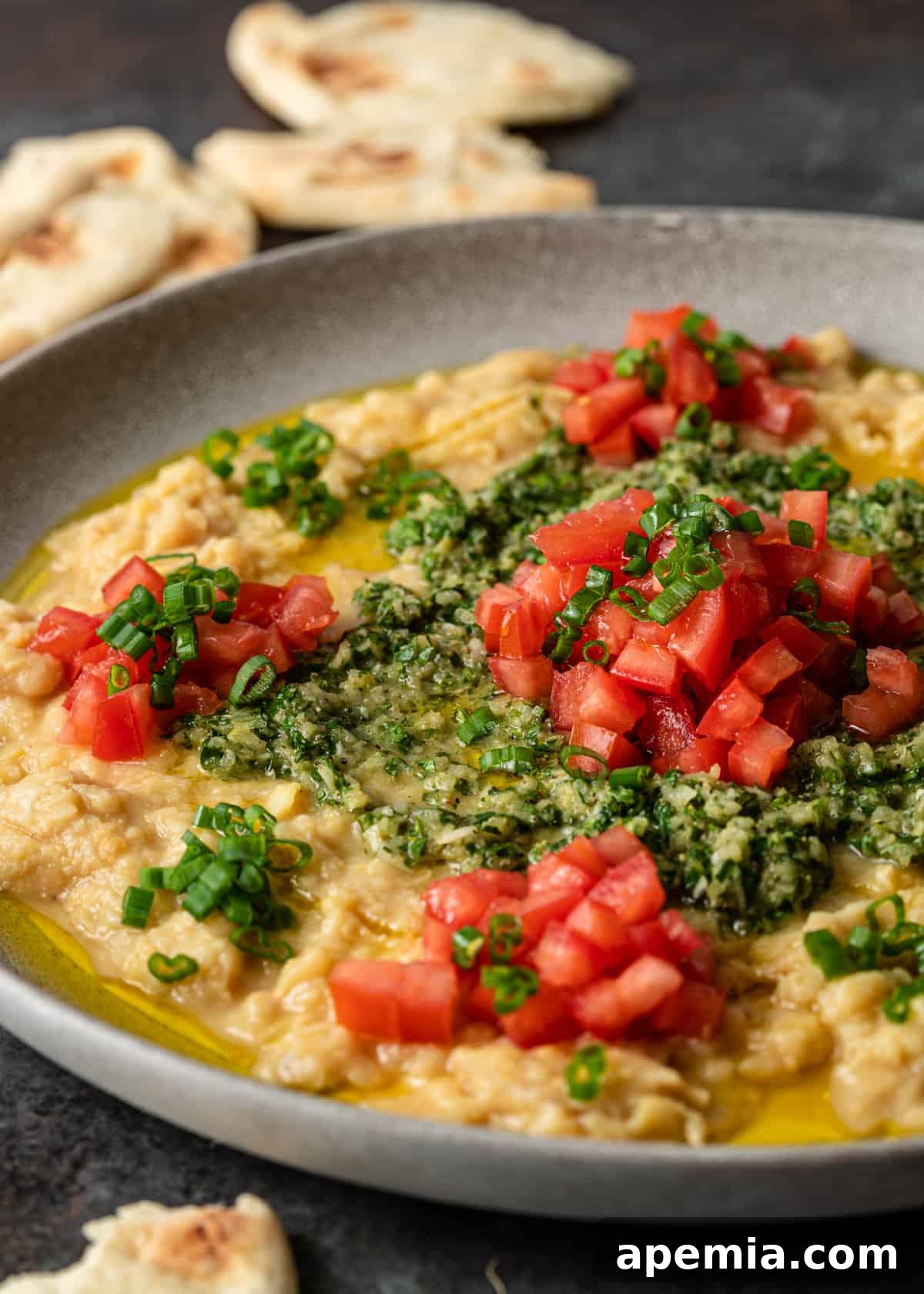 Close-up shot of a steaming plate of Lebanese ful medames, ready to be served.