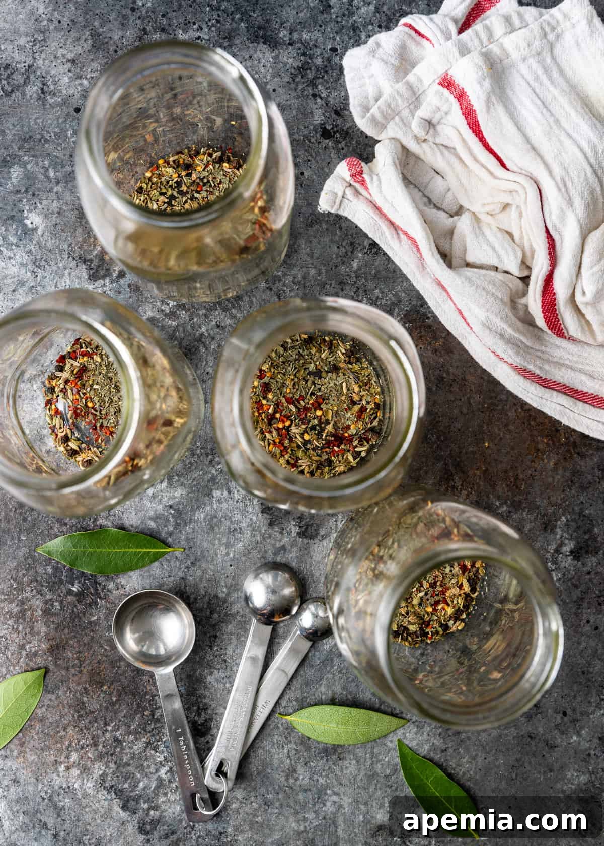 An organized overhead display of various spices and herbs, neatly arranged and ready for use in making Italian pickled vegetables.