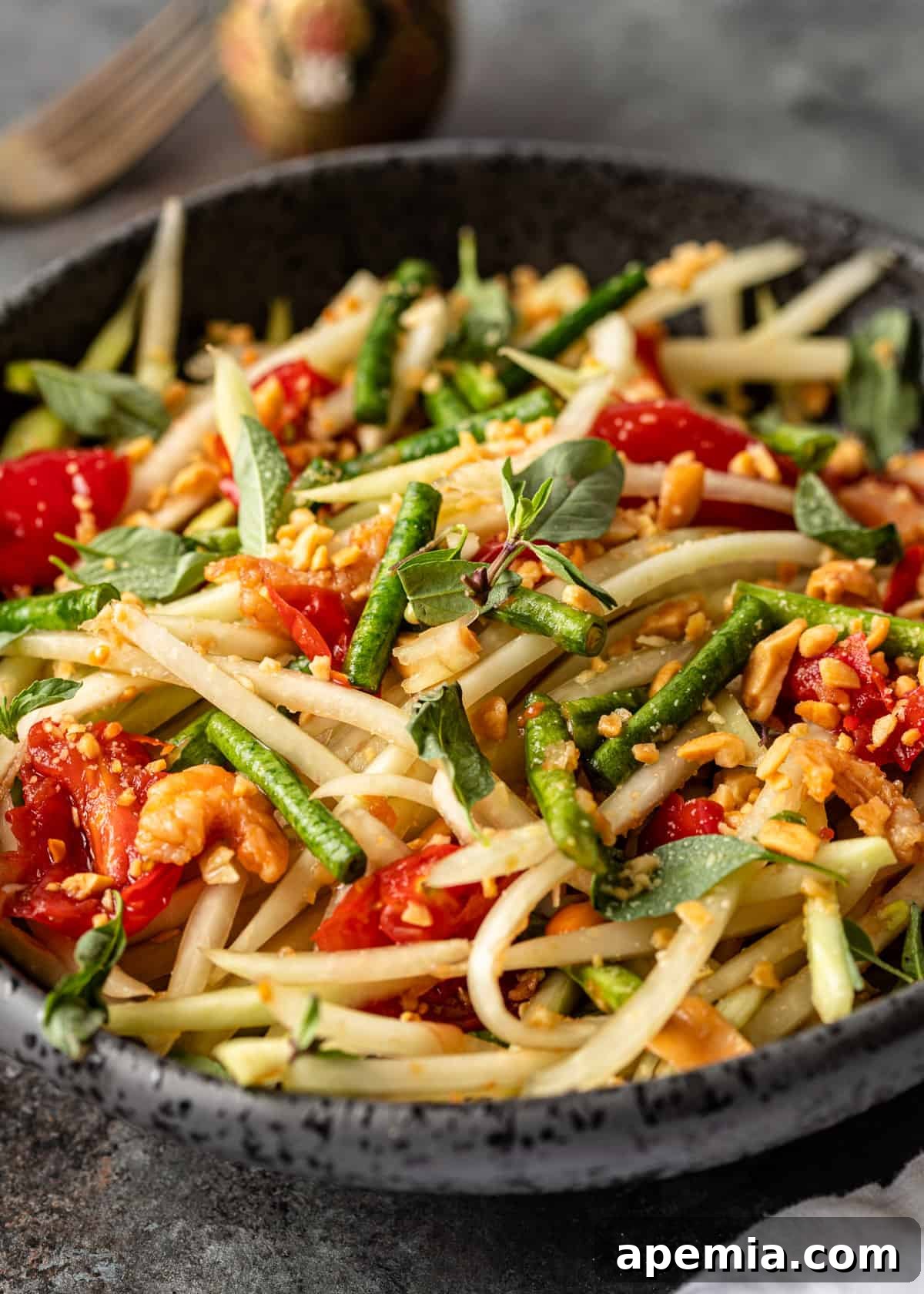 closeup: green papaya salad with vegetables and peanut sauce