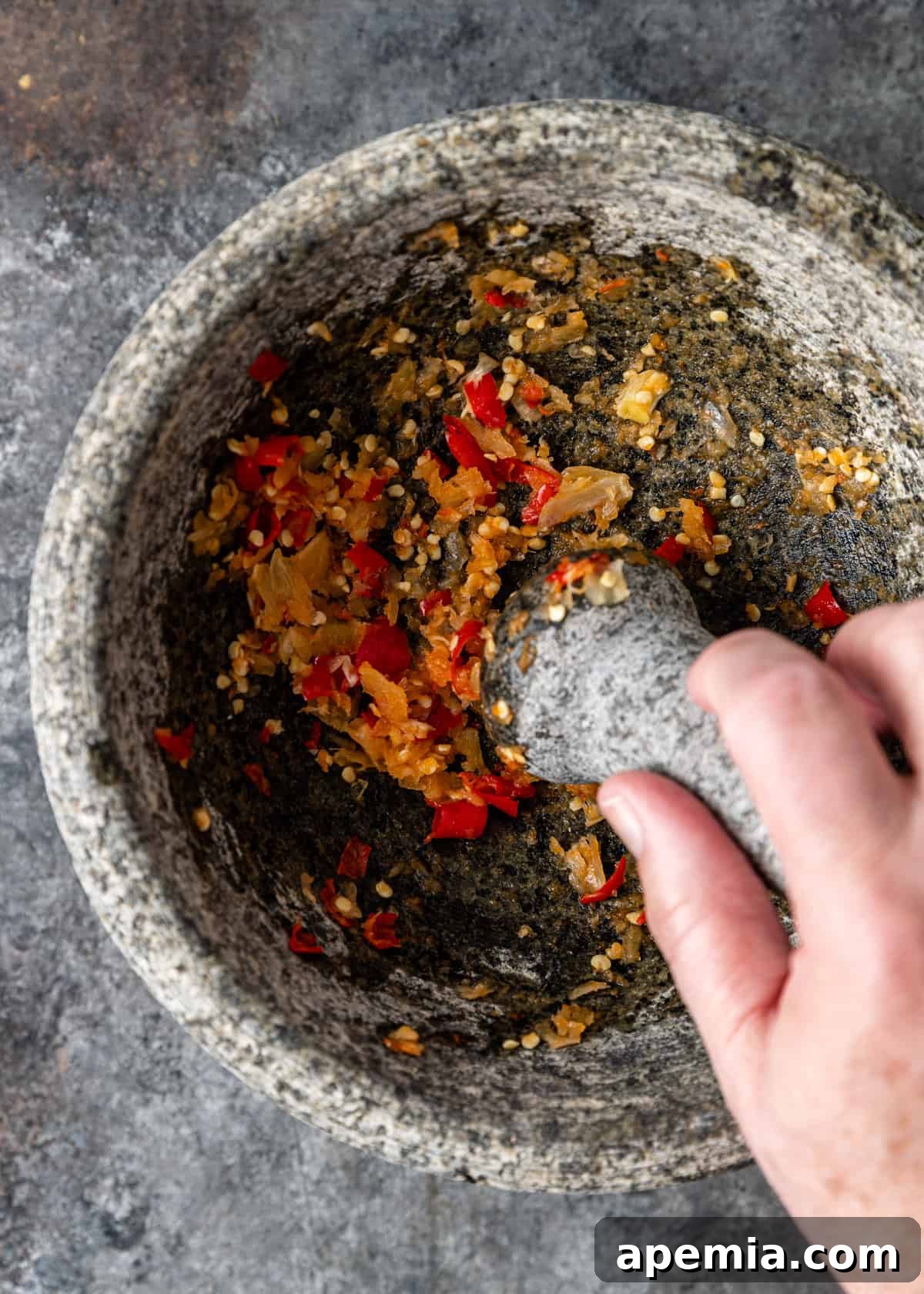 overhead: mashing chilis and garlic with mortar and pestle