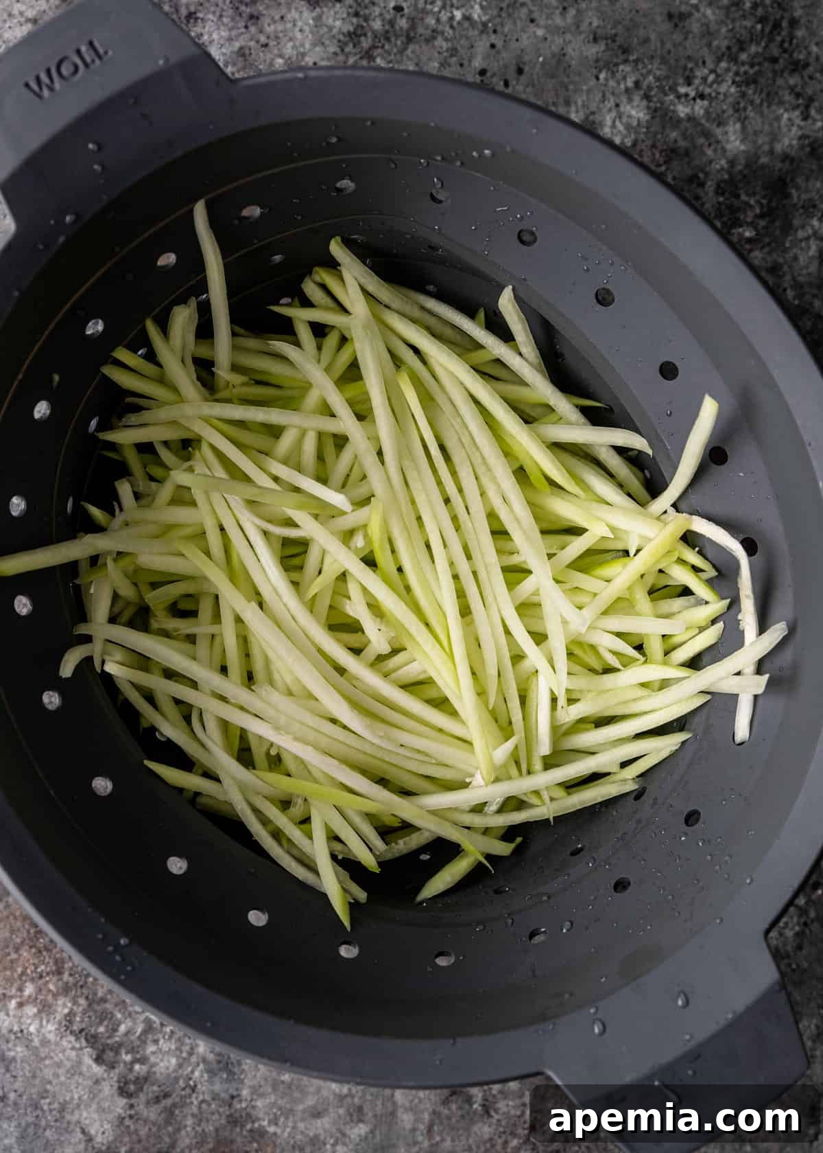 overhead: draining the shredded papaya in a colander 