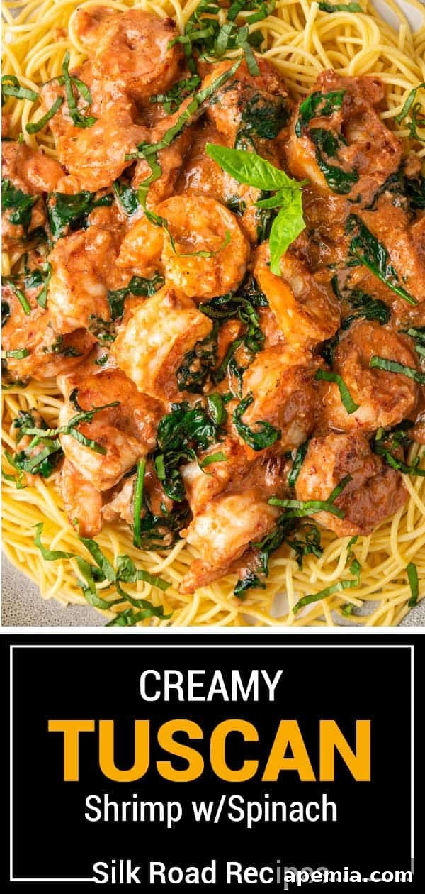 Beautifully plated creamy Tuscan shrimp with fresh spinach and basil, a perfect meal.
