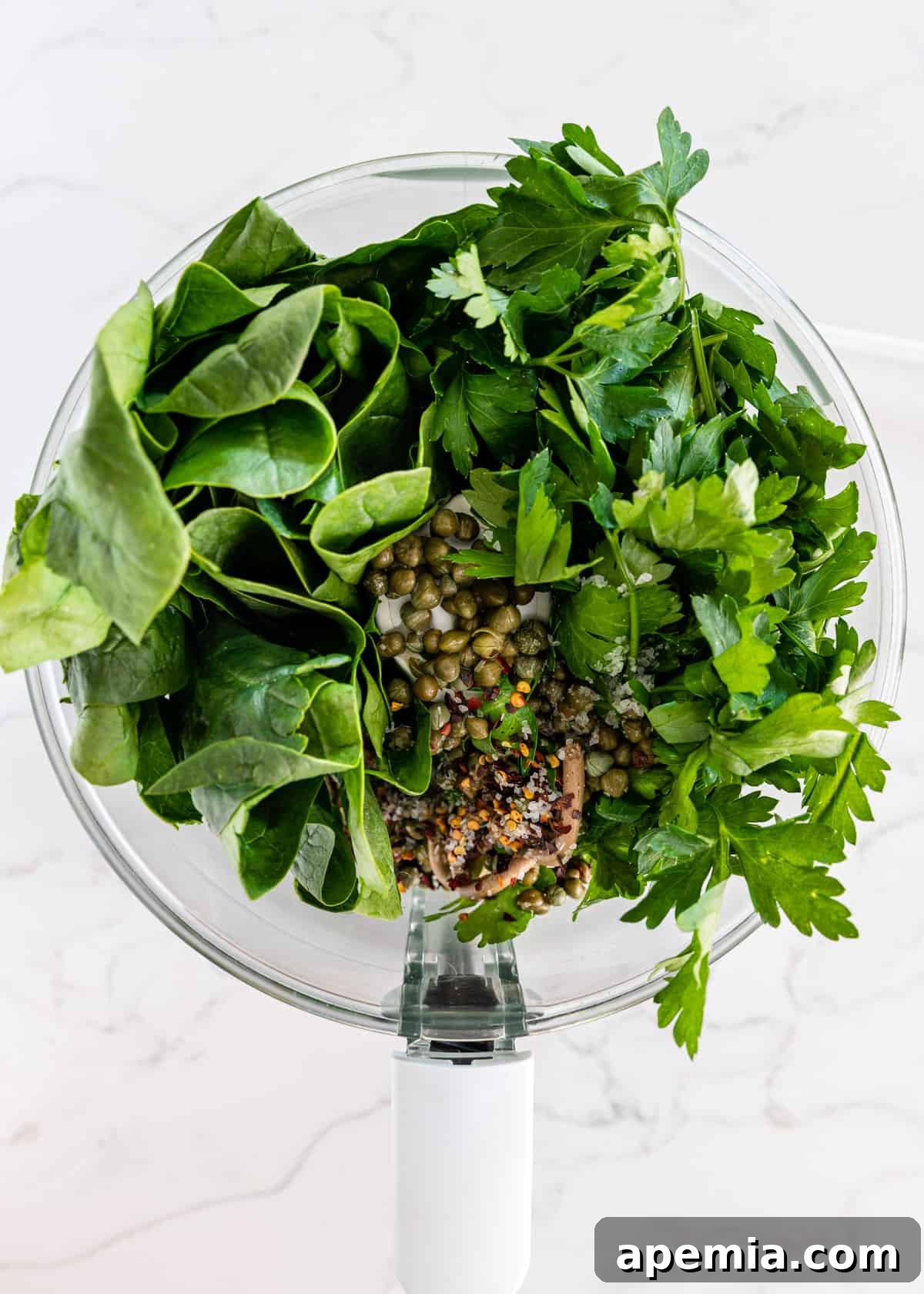 Vibrant Italian Green Sauce 4 overhead: ingredients for my italian salsa verde recipe in a food processor before processing
