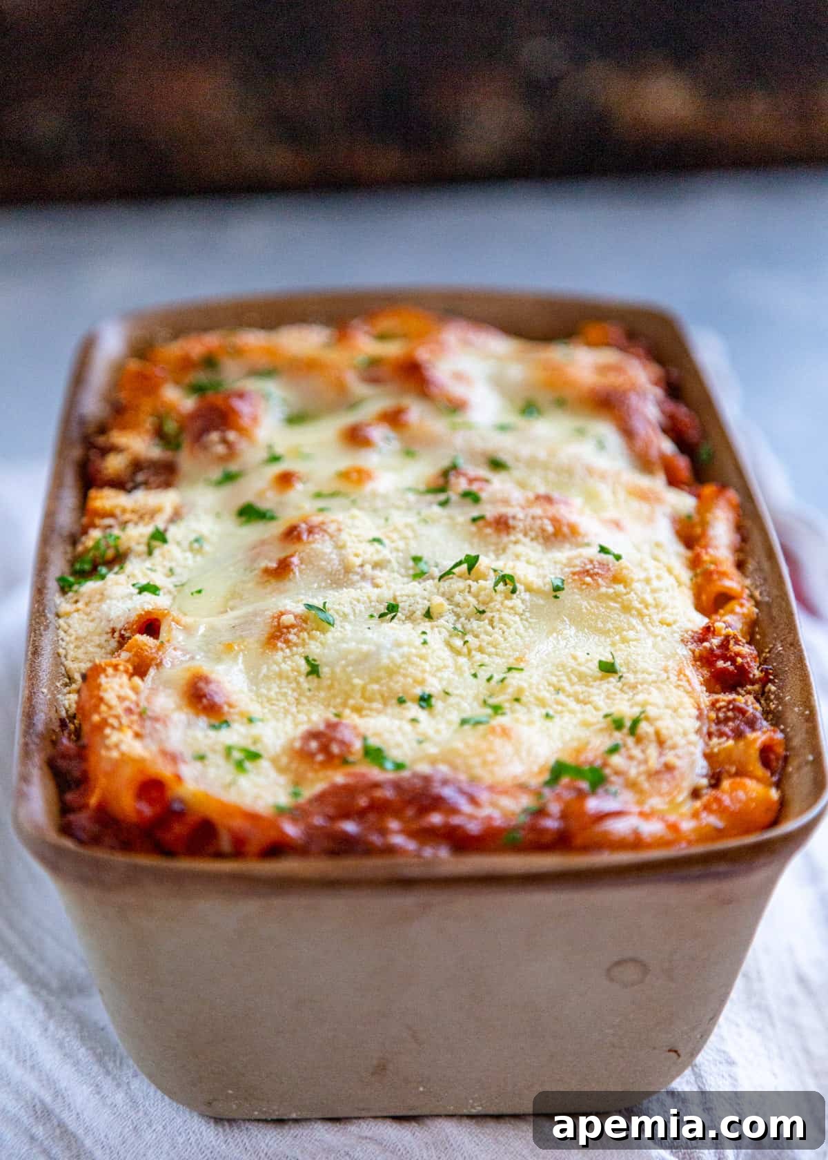 Close-up side view of baked ziti recipe after baking, showcasing the texture of the pasta and sauce