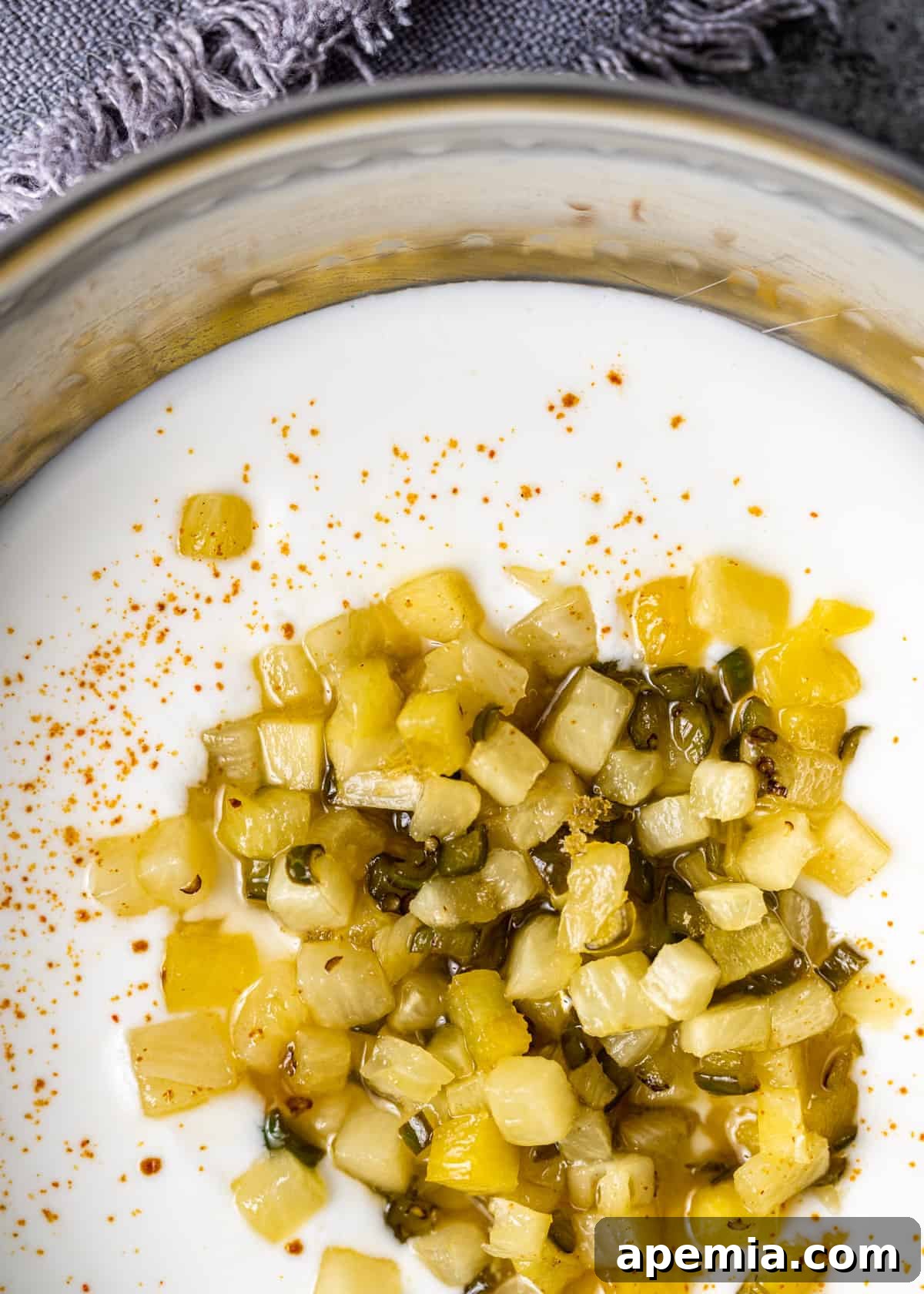overhead closeup: yogurt-based pineapple raita with sautéed pineapples on top