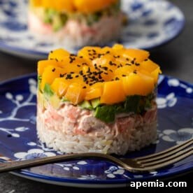Mango Shrimp Sushi Stacks, a vibrant dish with coconut rice, spicy shrimp, avocado, and fresh mango