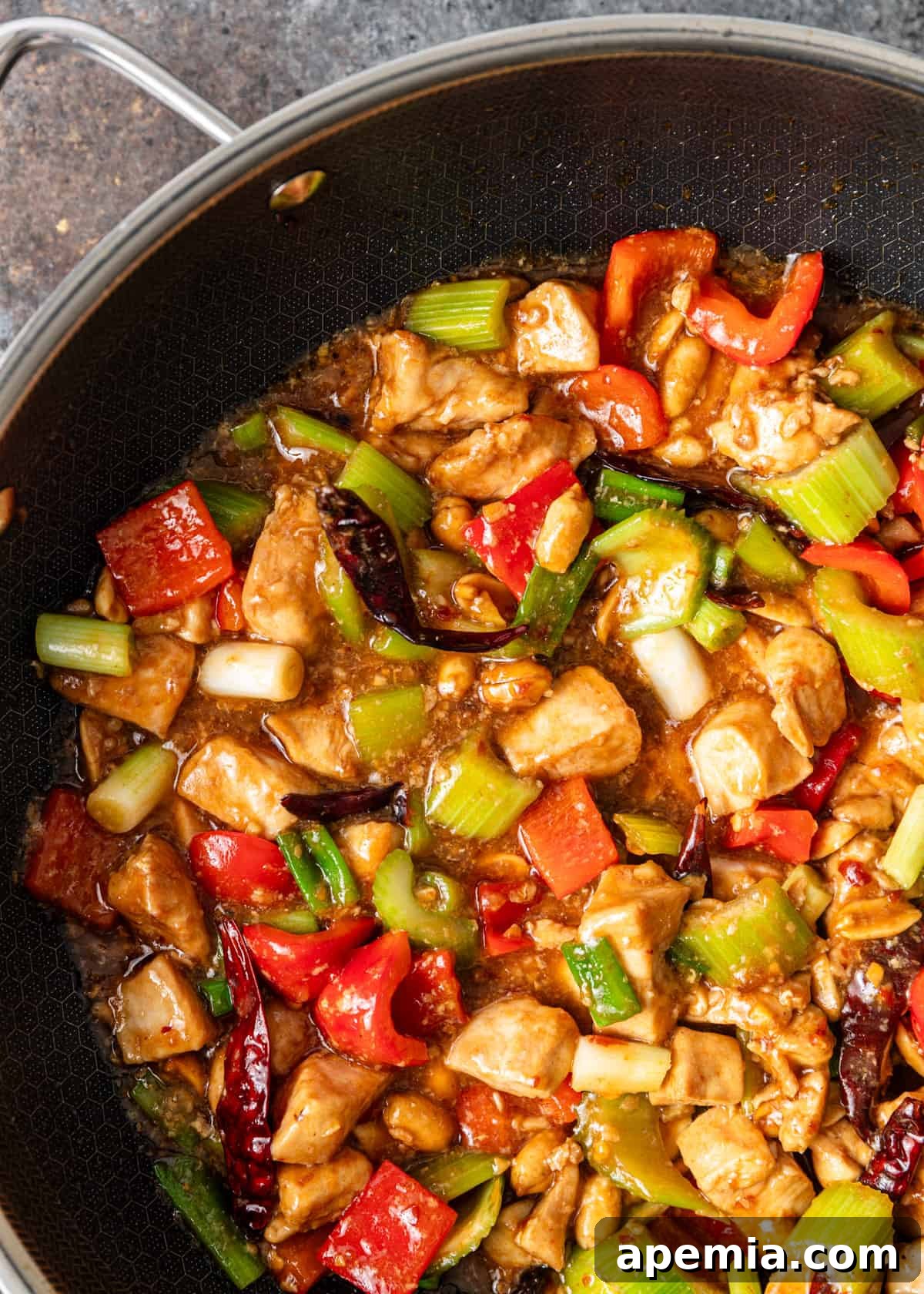 overhead closup: cooking kung pao chicken in a skillet